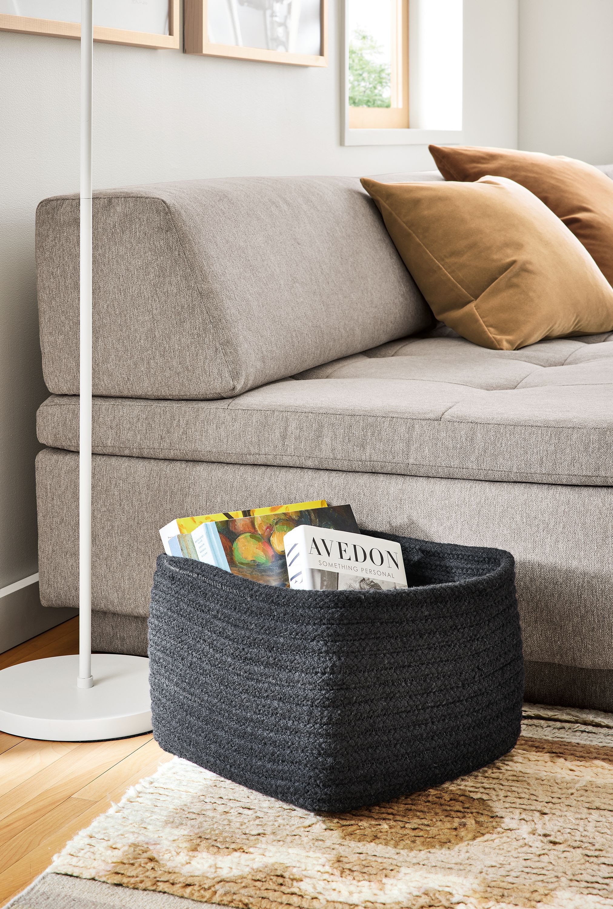 Living area with Kori square storage basket in black and Miranda sectional in Elin Cement fabric.