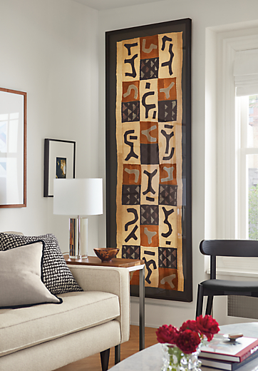living room featuring large, framed vintage kuba textile