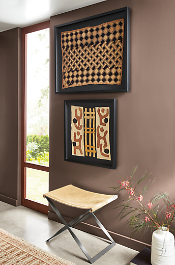 entryway featuring small and large framed vintage kuba textiles