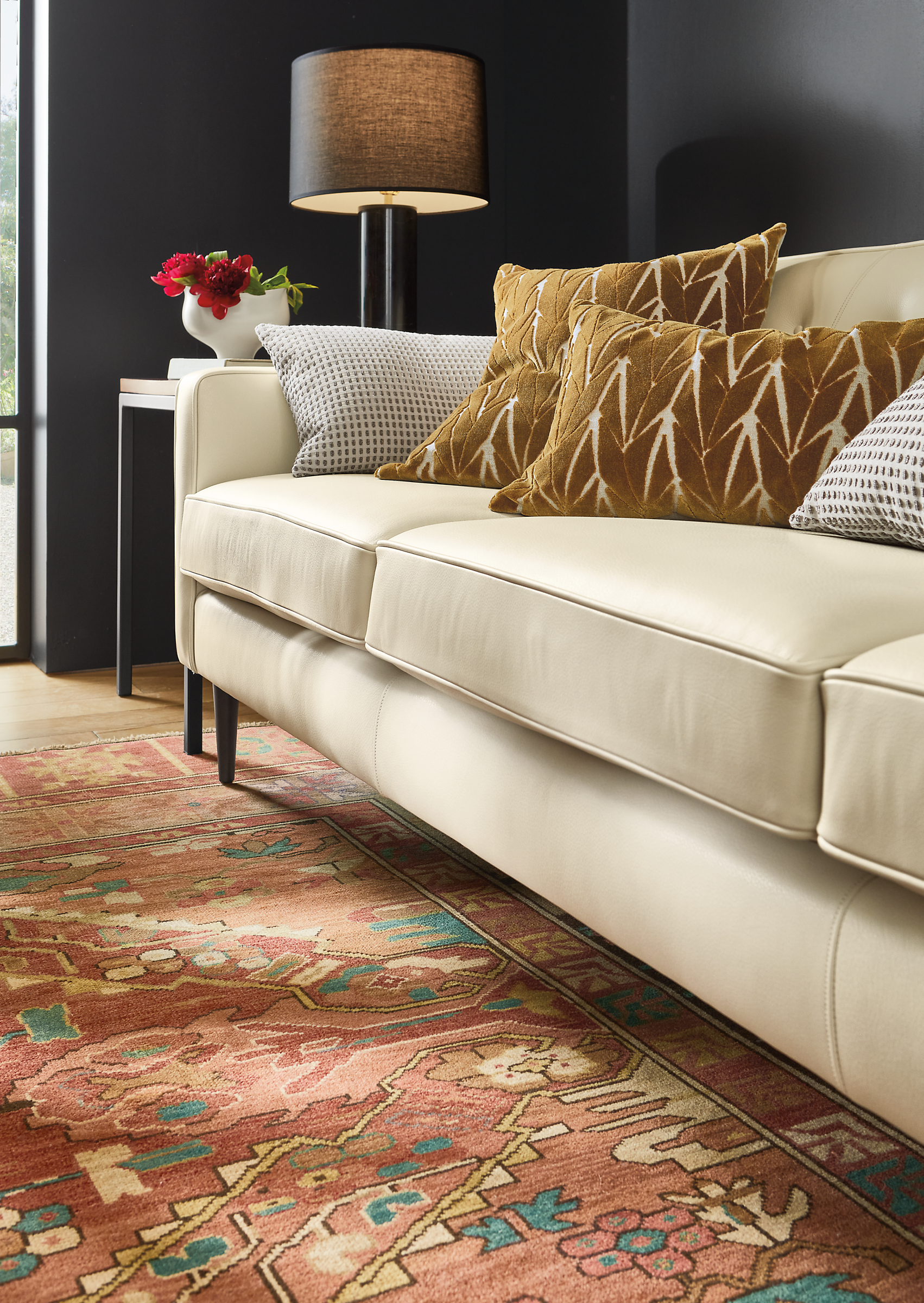 room setting with kayseri rug, holmes leather sofa, branch throw pillows.