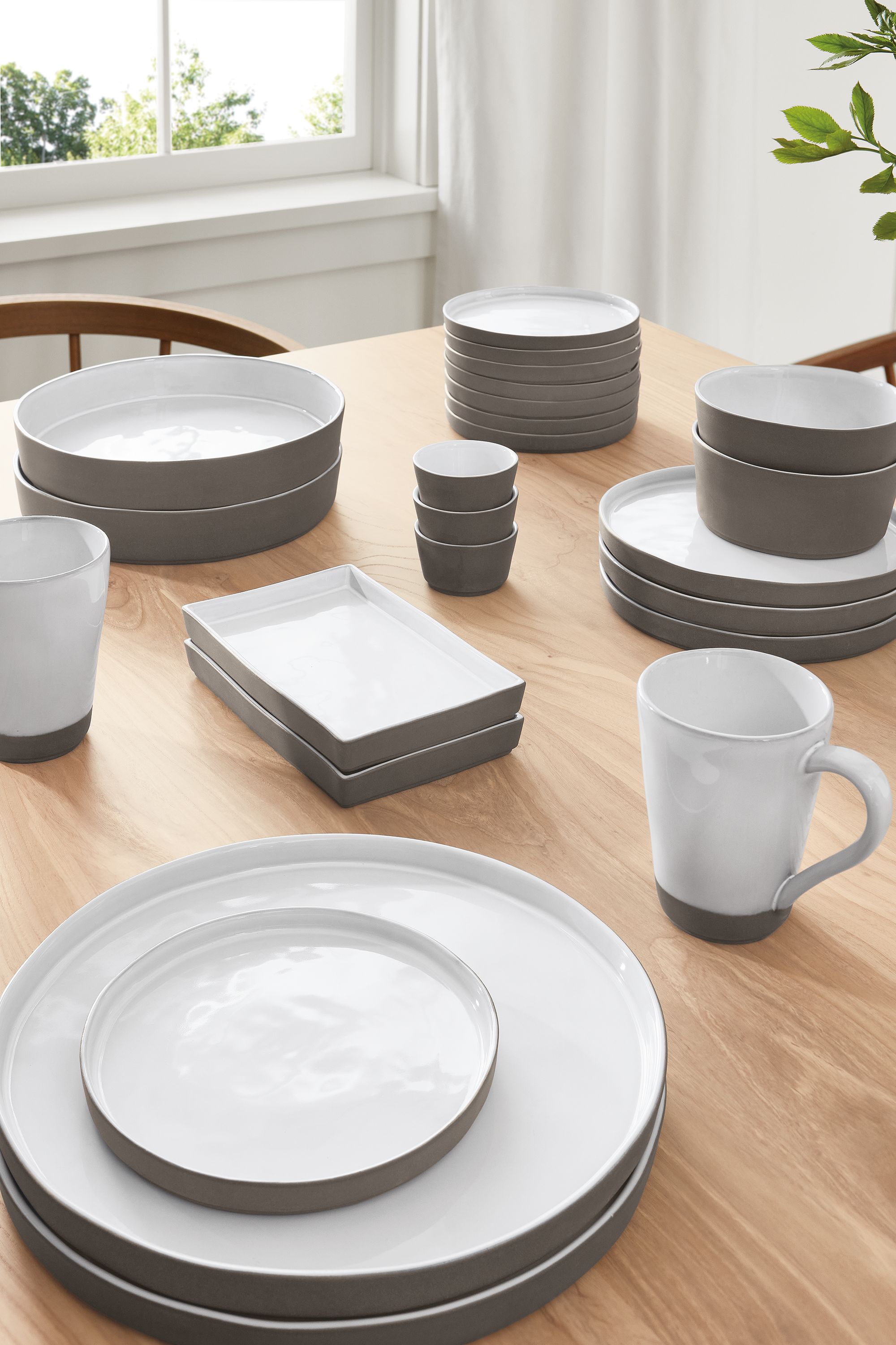 detail of Lagoa dinner plates, bowls and cups on tabletop.