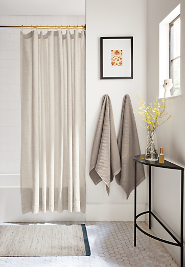 bathroom with langdon shower curtain, lawrence bath towels and slim console table.