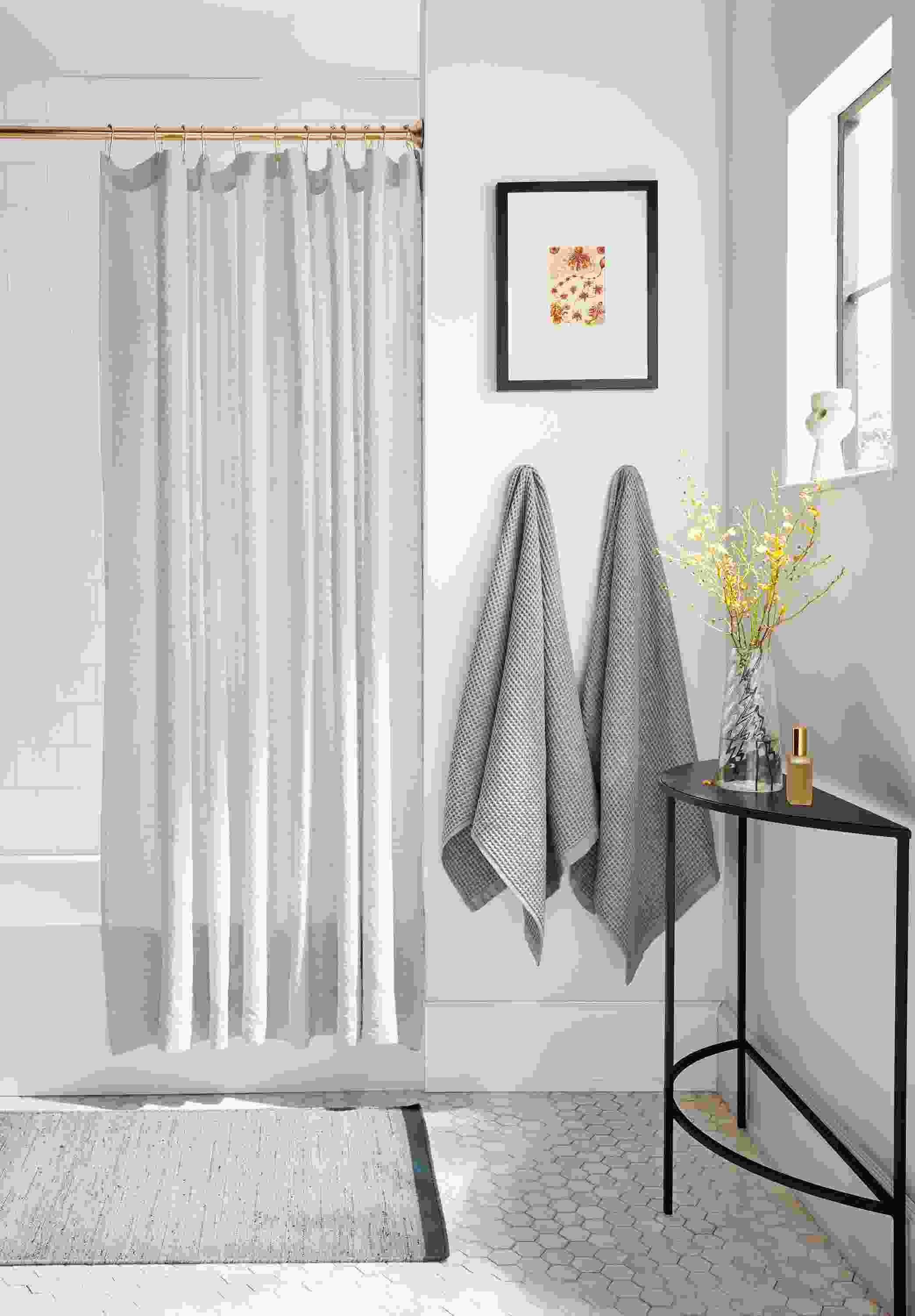 bathroom with langdon shower curtain, lawrence bath towels and slim console table.