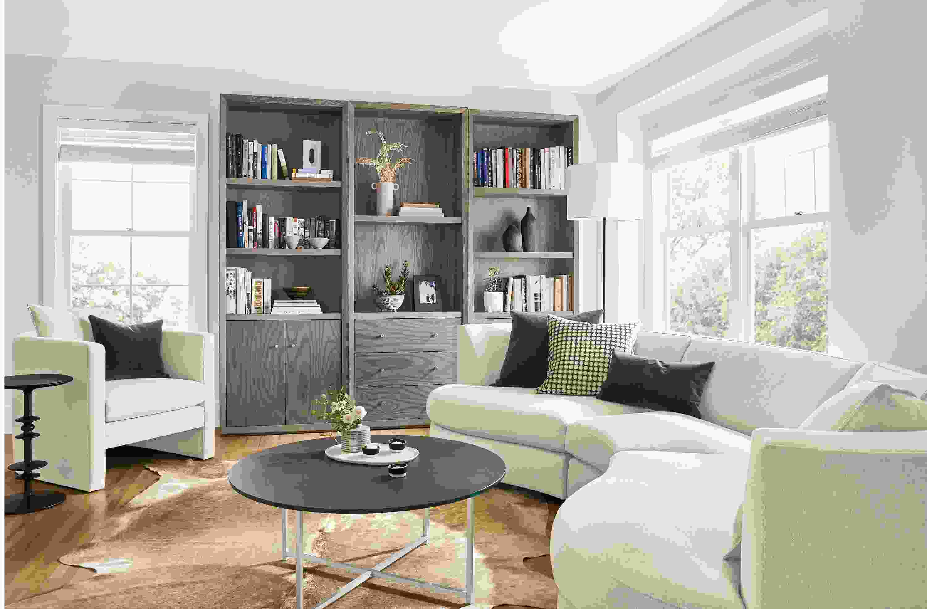 Detail of Astaire curved sofa and Lennox bookcases in living room.