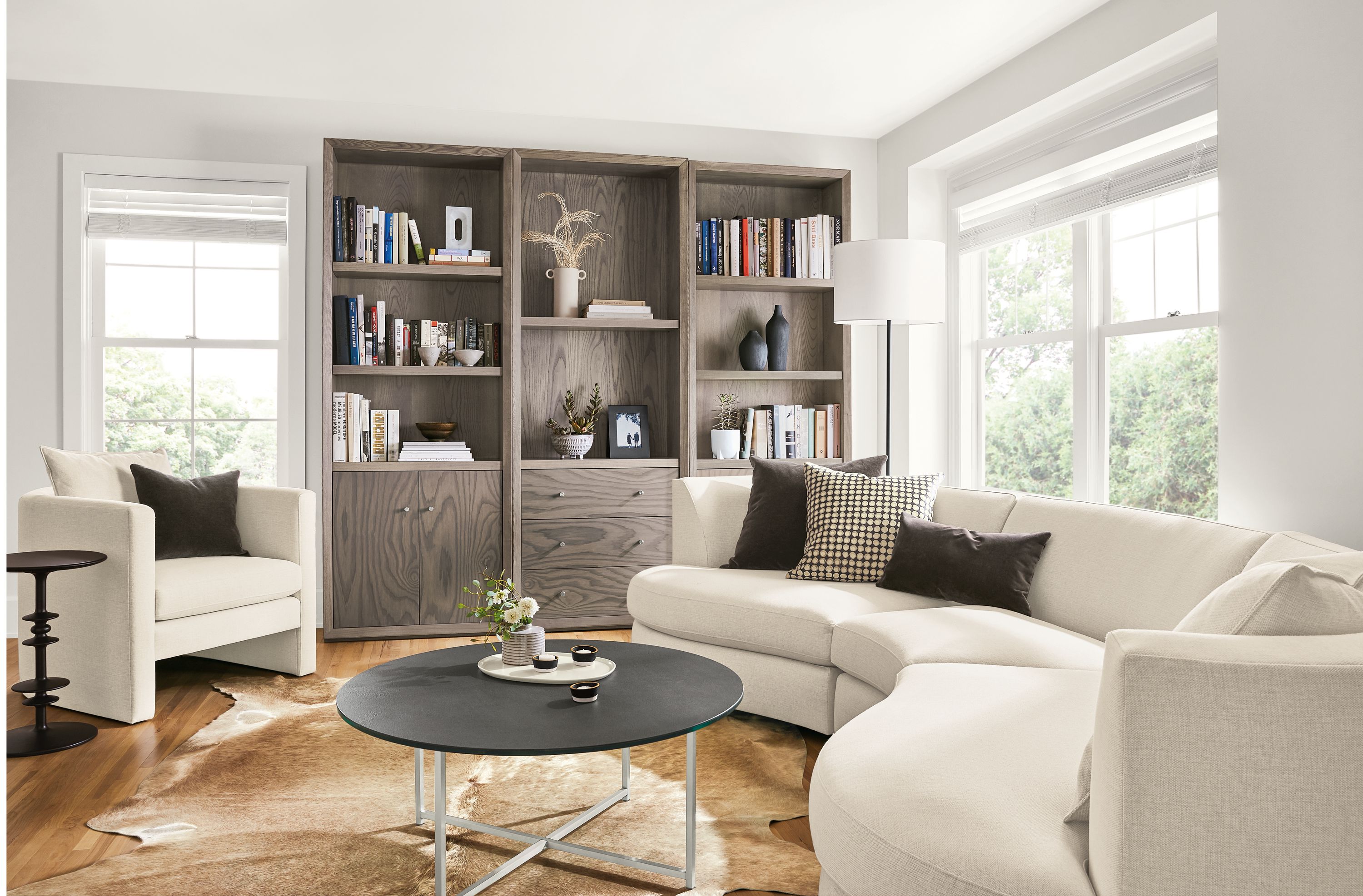 Detail of Astaire curved sofa and Lennox bookcases in living room.