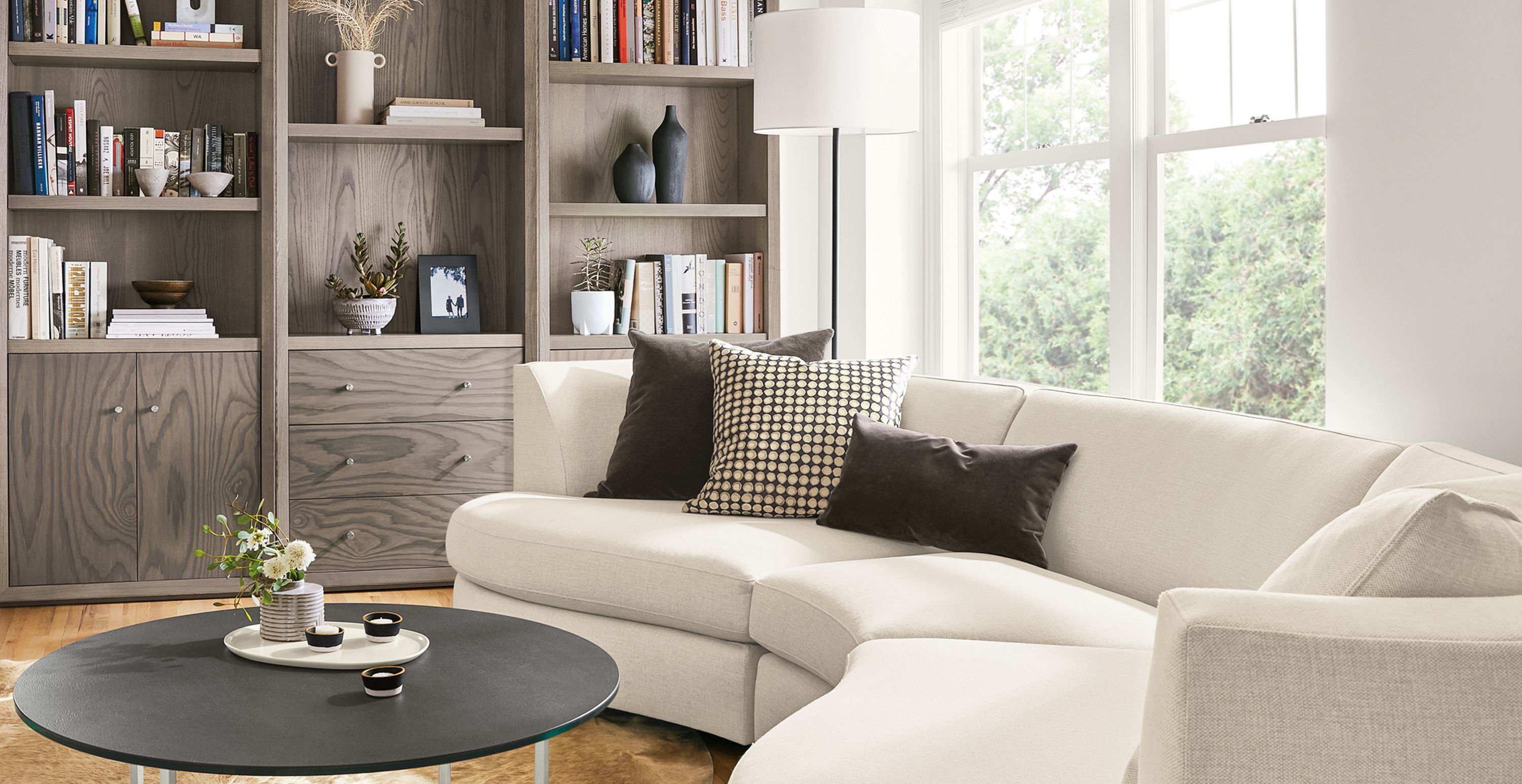 Detail of Astaire curved sofa and Lennox bookcases in living room.