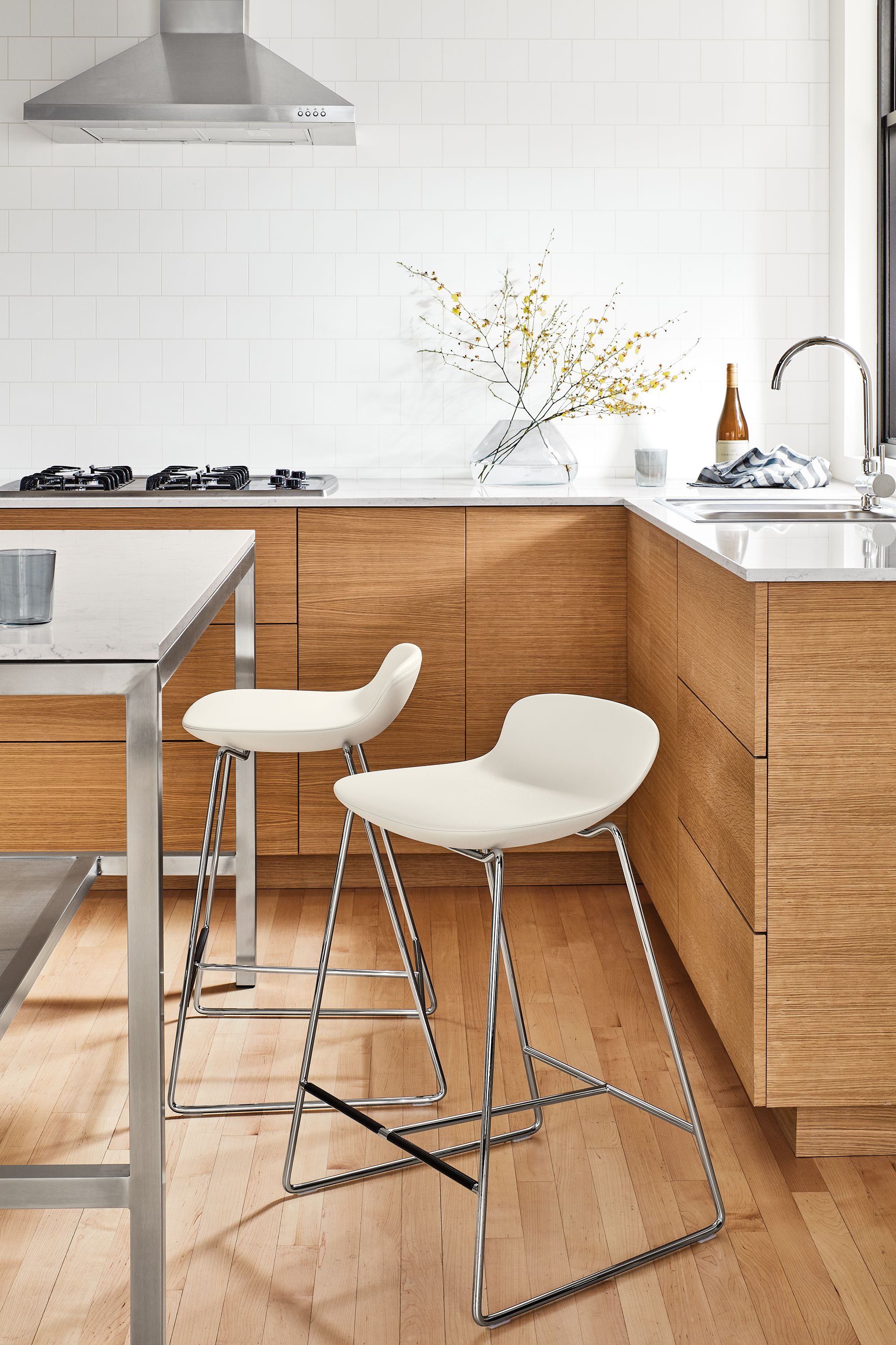 parsons counter table in kitchen with two leo counter stools.