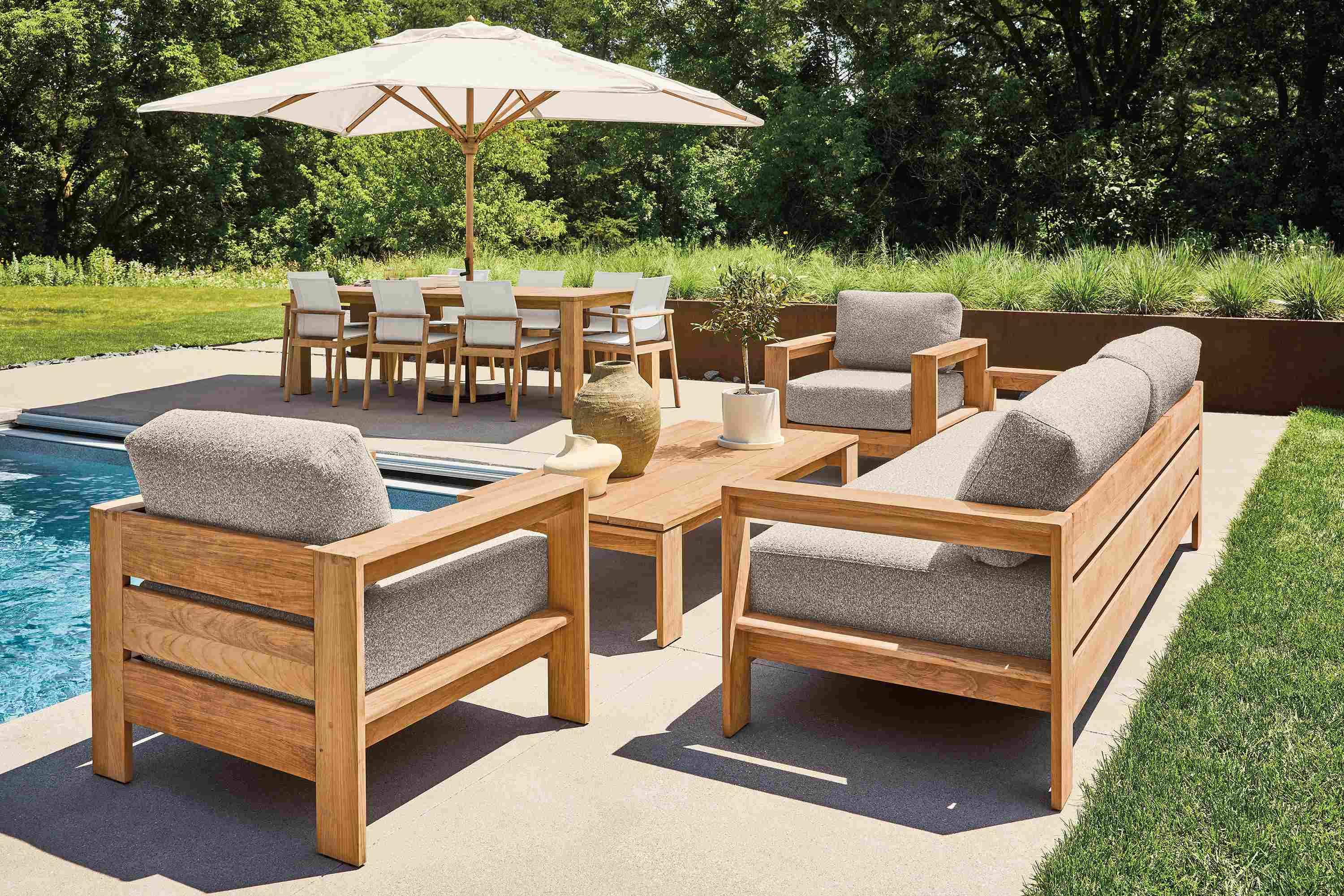Pool patio with Leti sofa, 2 Leti lounge chairs and Leti coffee table in Teak Heartwood and Kloss Otter fabric.