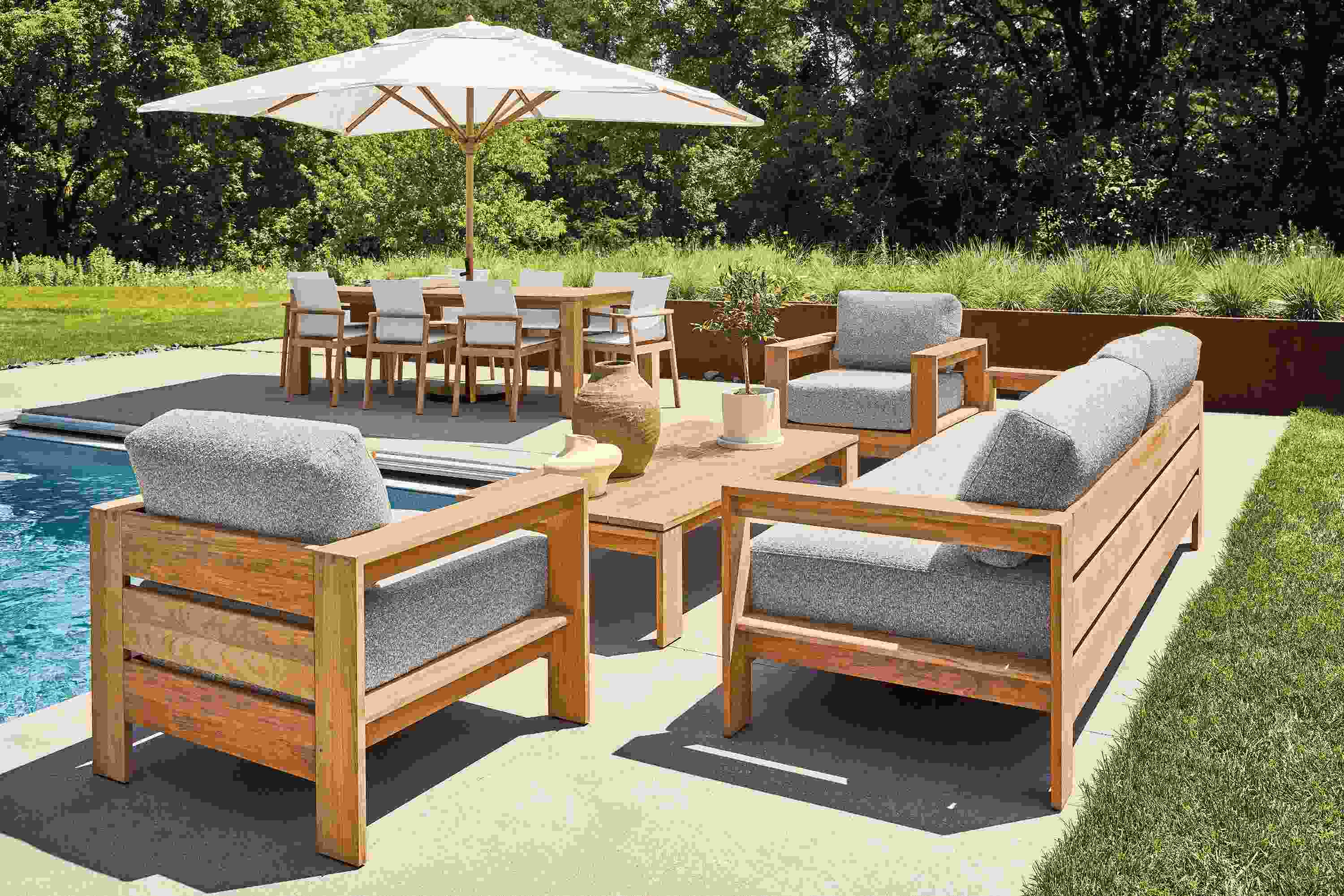 Pool patio with Leti sofa, 2 Leti lounge chairs and Leti coffee table in Teak Heartwood and Kloss Otter fabric.
