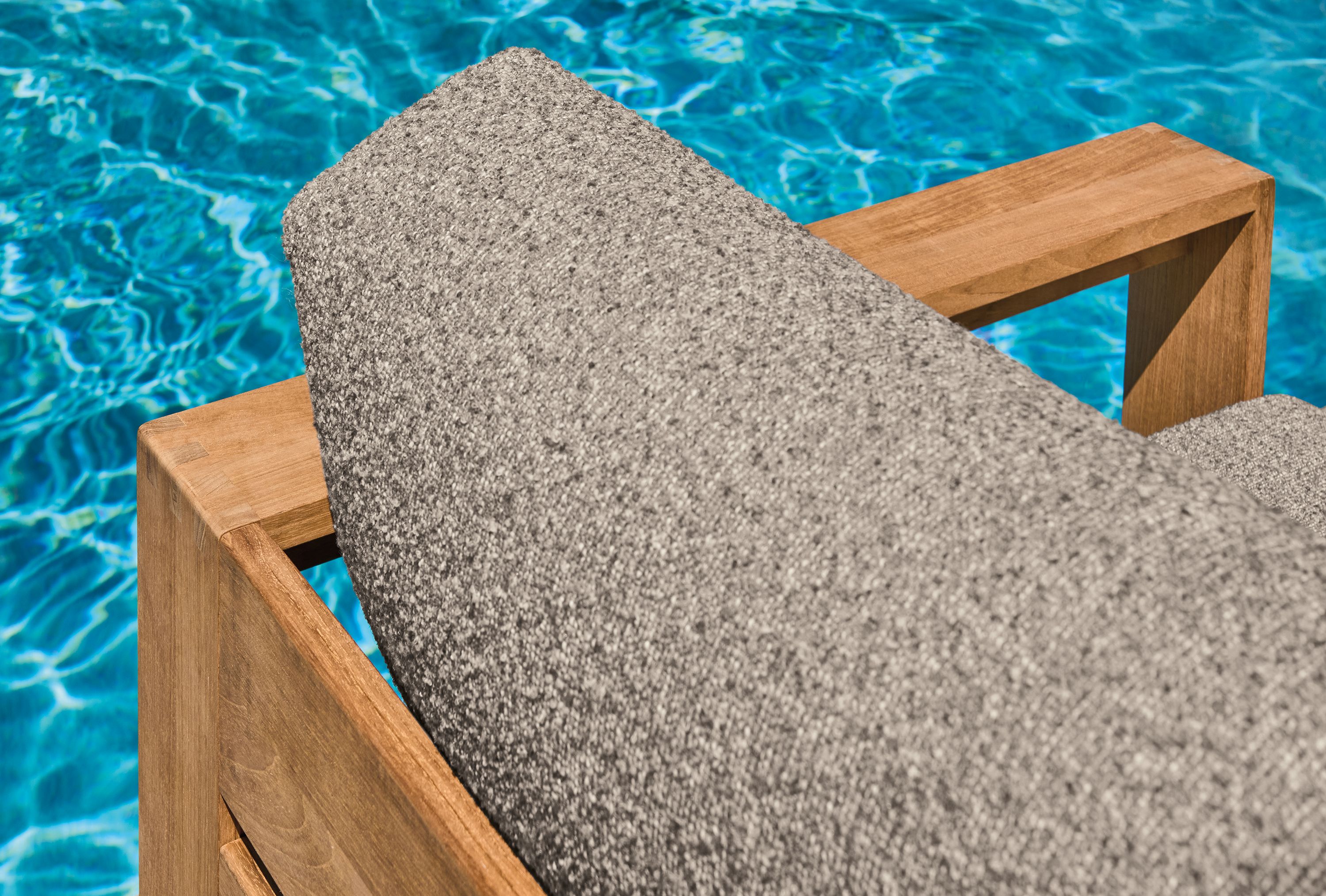 High-angle detail of Kloss Otter fabric on a Leti lounge chair in teak heartwood.
