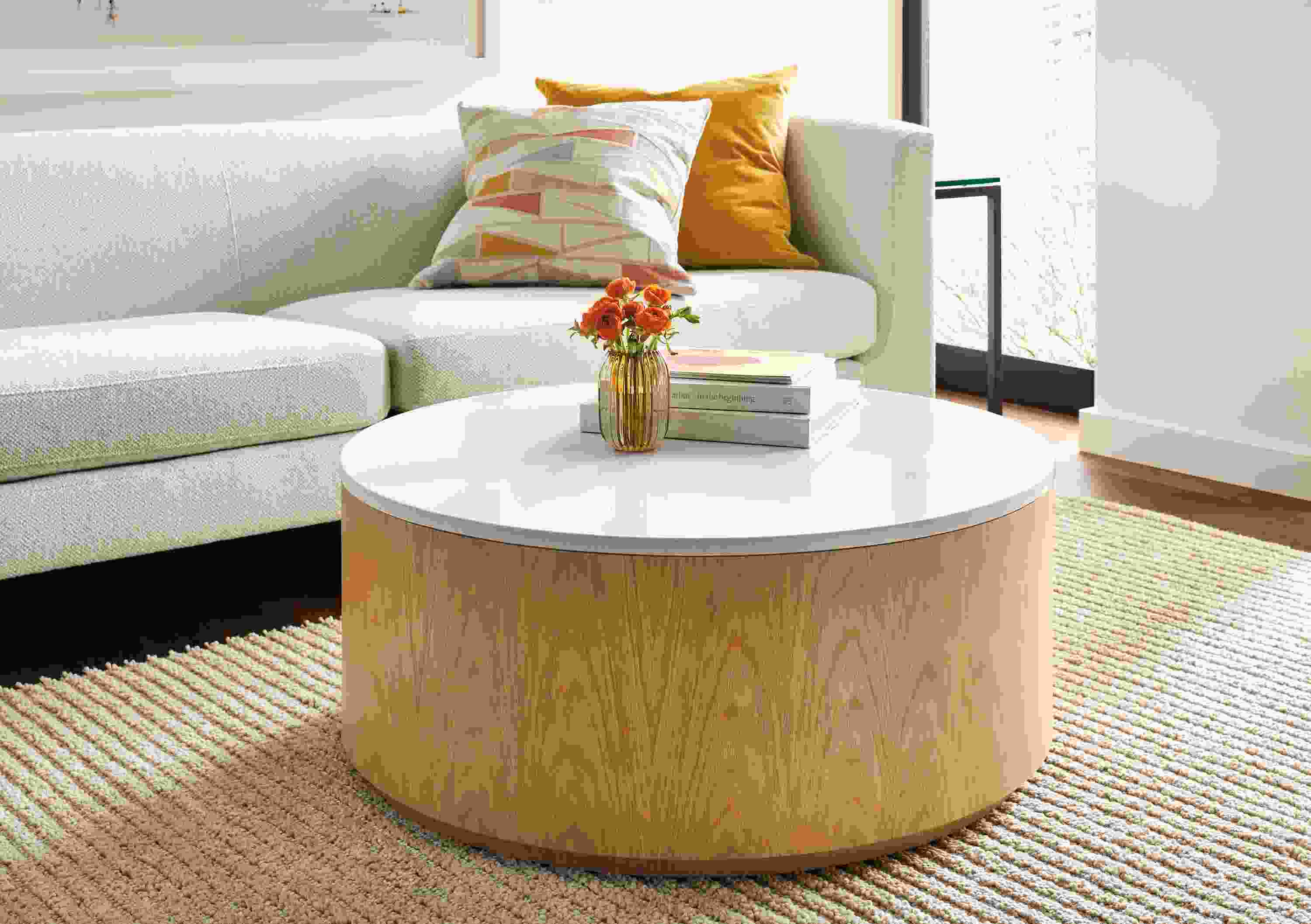 Living room with Liam 36-diameter coffee table in white oak with white quartz and Arden rug in oatmeal.