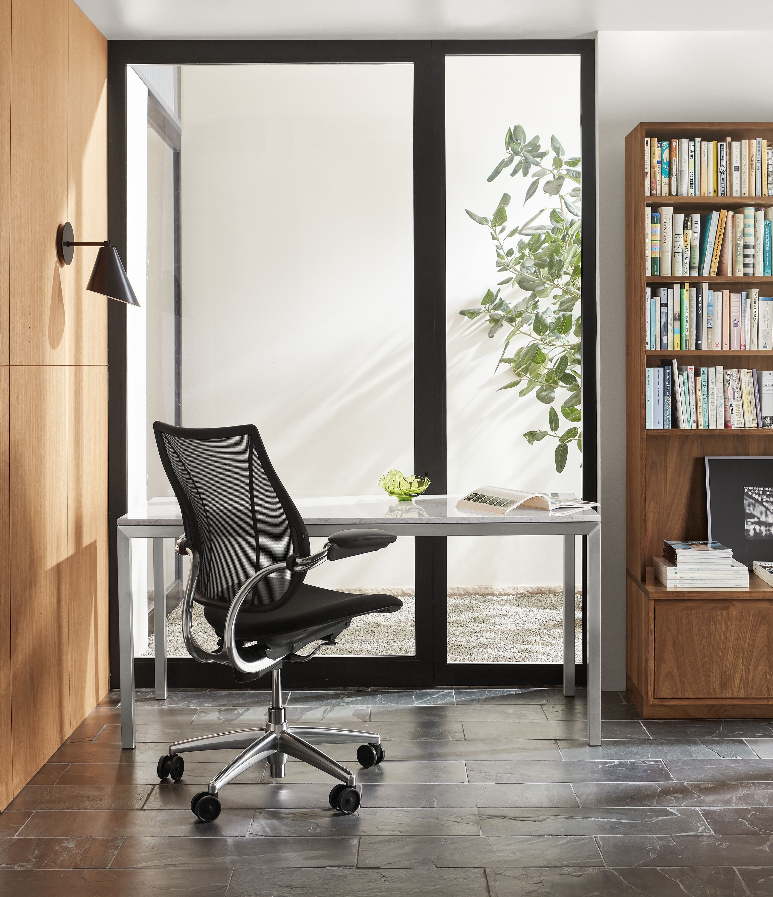 room setting with liberty office chair, parsons table, keaton bookcase.