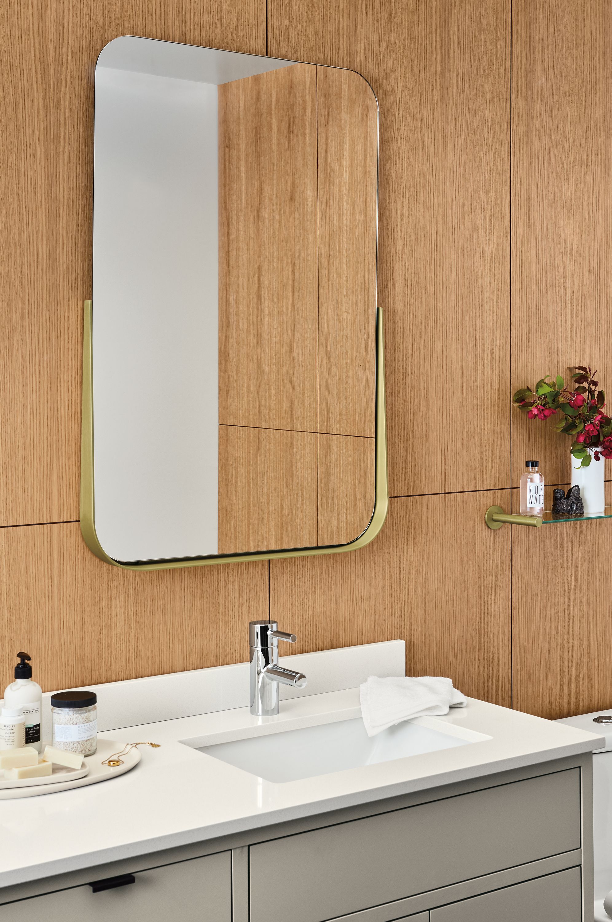 Bathroom with Lilia mirror in brushed gold powdercoat and copenhagen bathroom vanity in taupe.