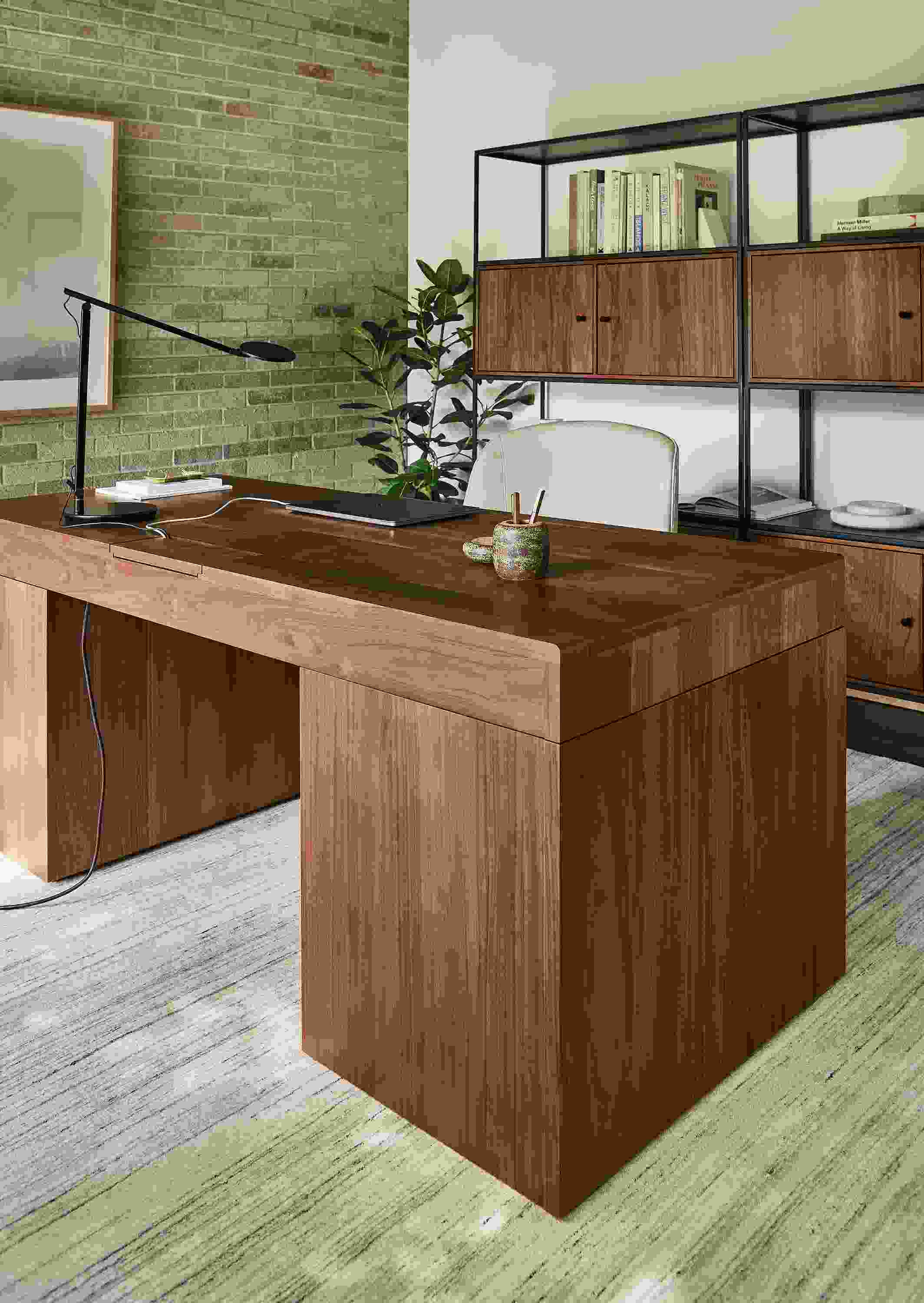 Office with lincoln adjustable standing desk in walnut and slim 4-door insert bookcase in natural steel and walnut.