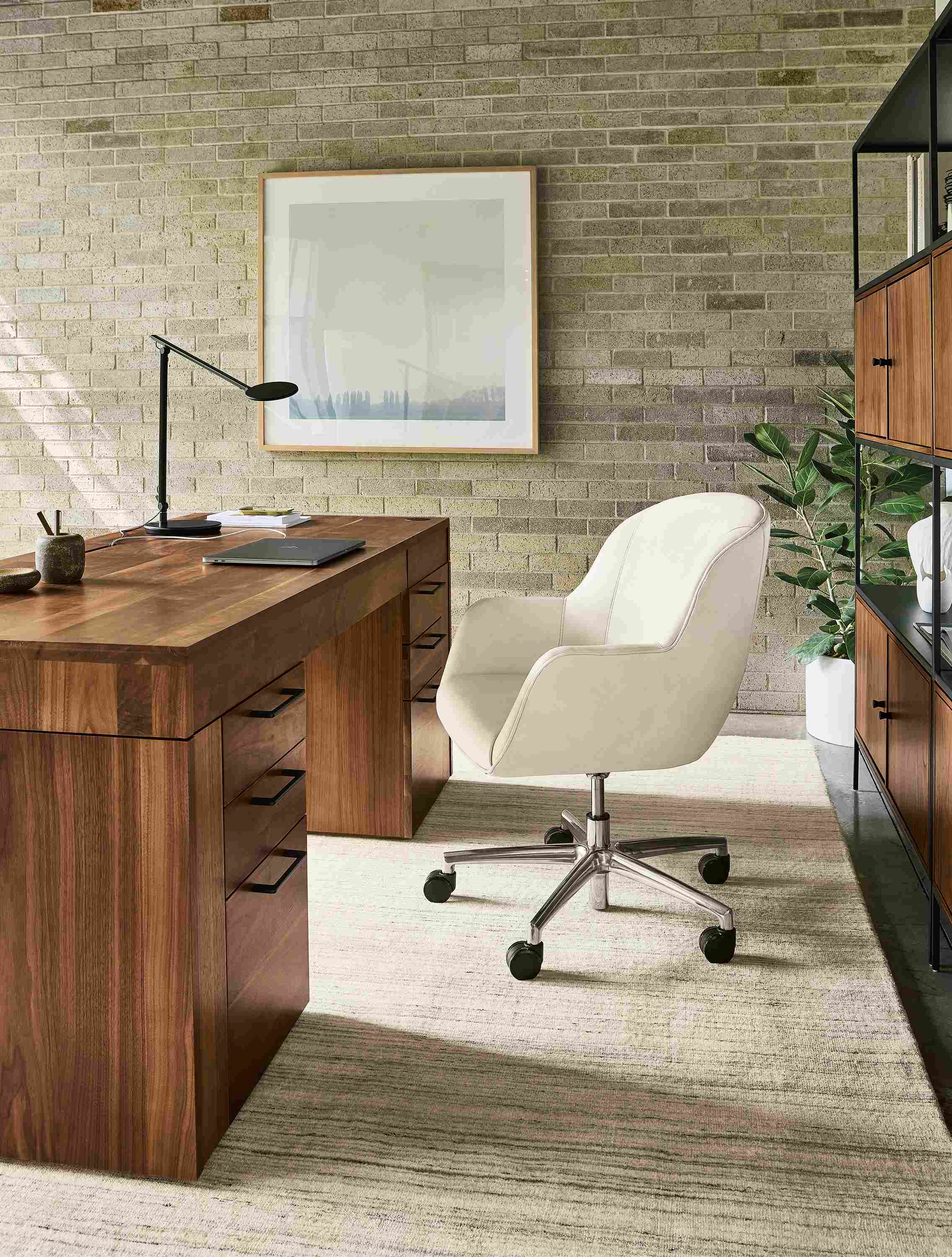 Office with lincoln adjustable standing desk with right and left drawers in walnut and nico chair in laino bone leather.