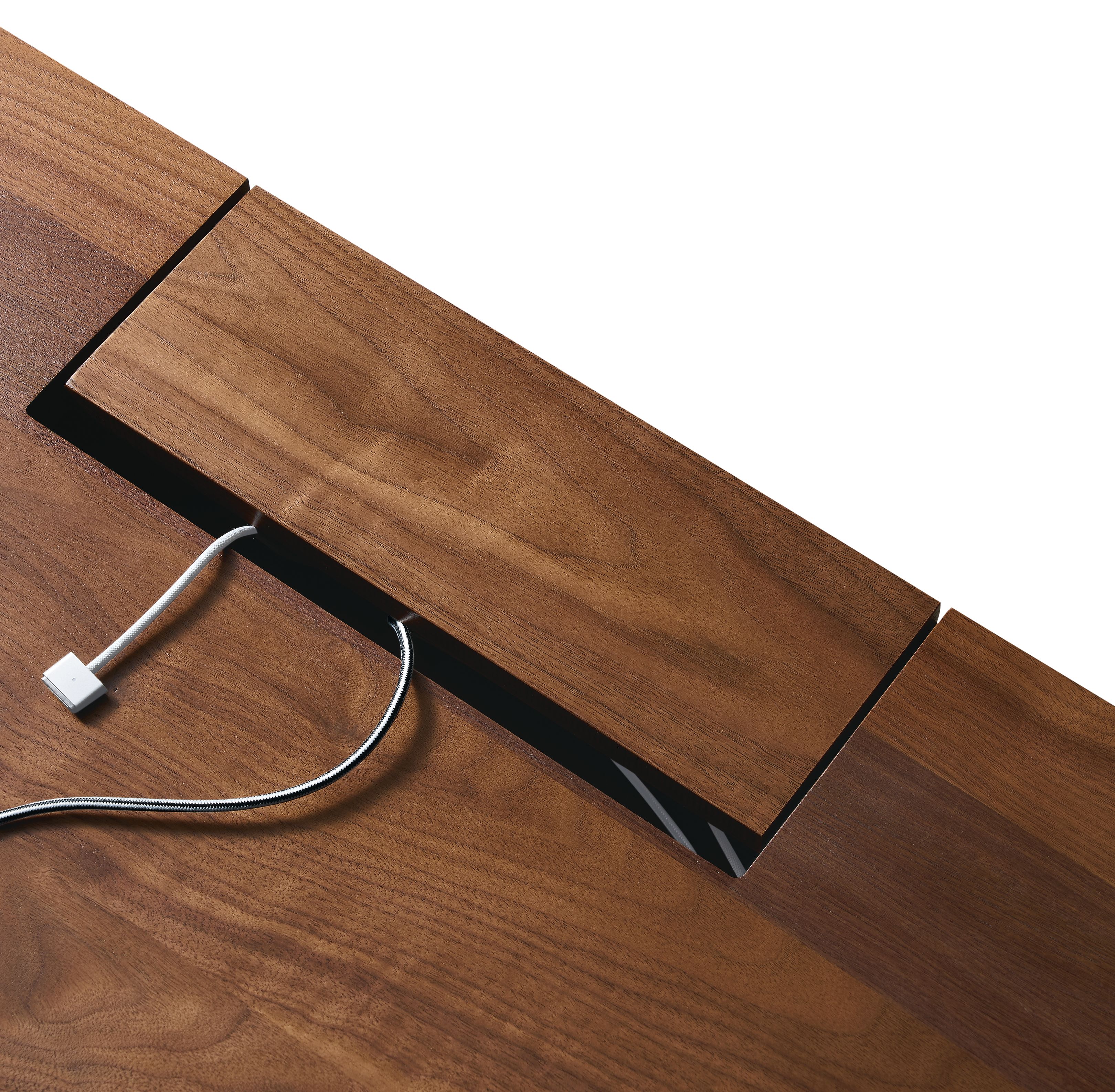 Detail of hinged cord access cover shown closed on Lincoln 72-wide adjustable standing desk in walnut.