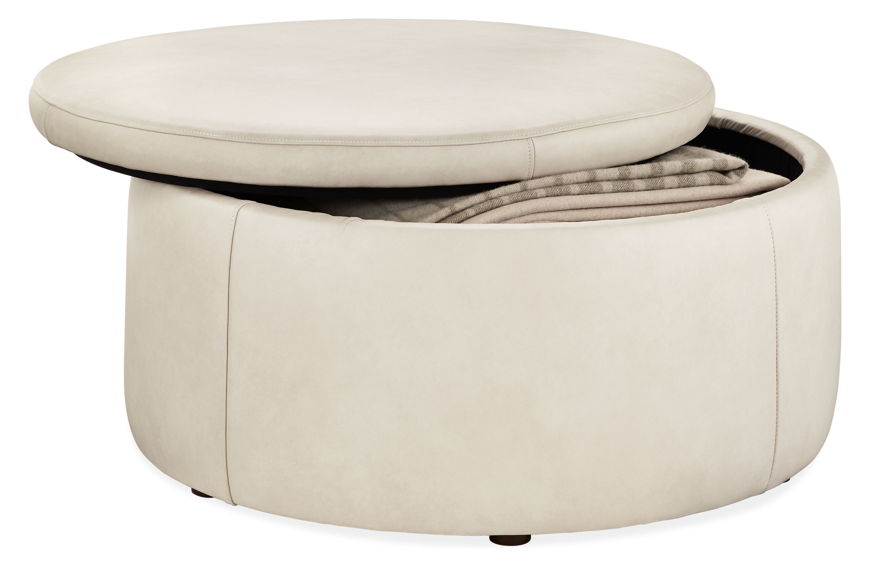 open detail of lind 36-round storage ottoman in laino bone leather.