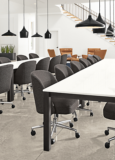 Detail of Linden tables with white quartz top in business setting.