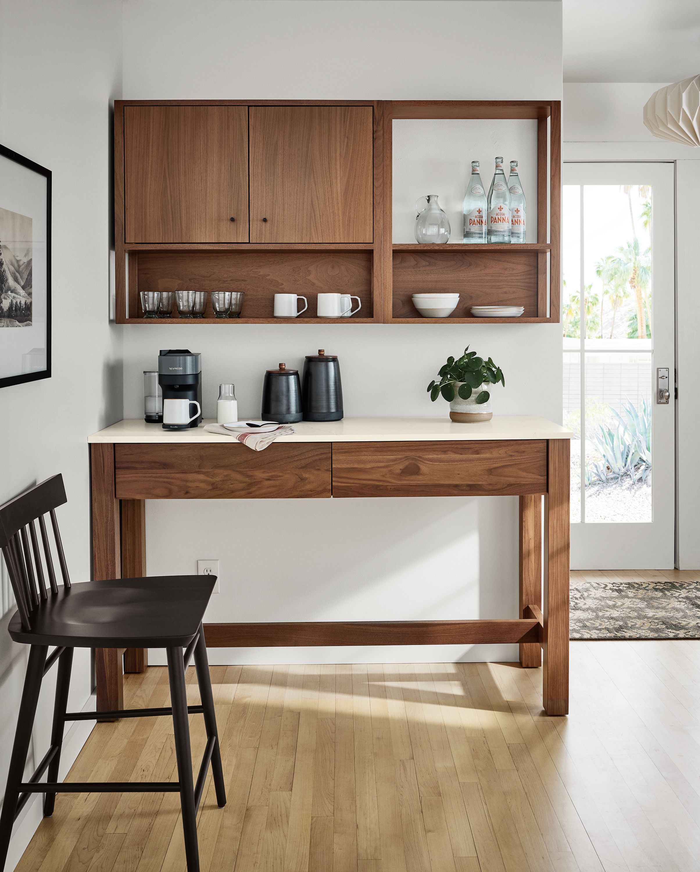 Kitchen with Linden Kitchen island and Tobias wall cabinet and shelf unit all in walnut and Thatcher counter stool in charcoal.