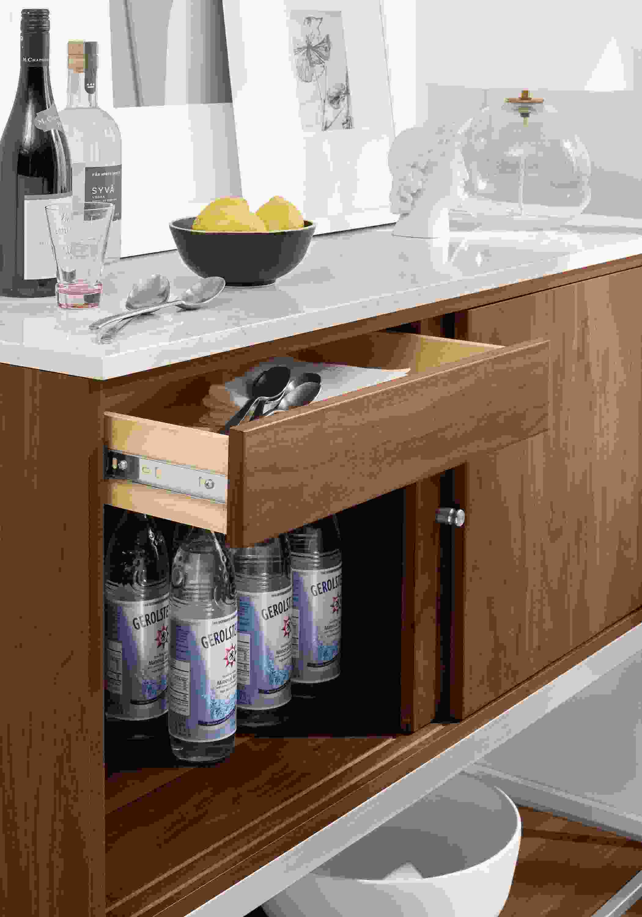 Side detail of Linear bar cabinet open drawers.