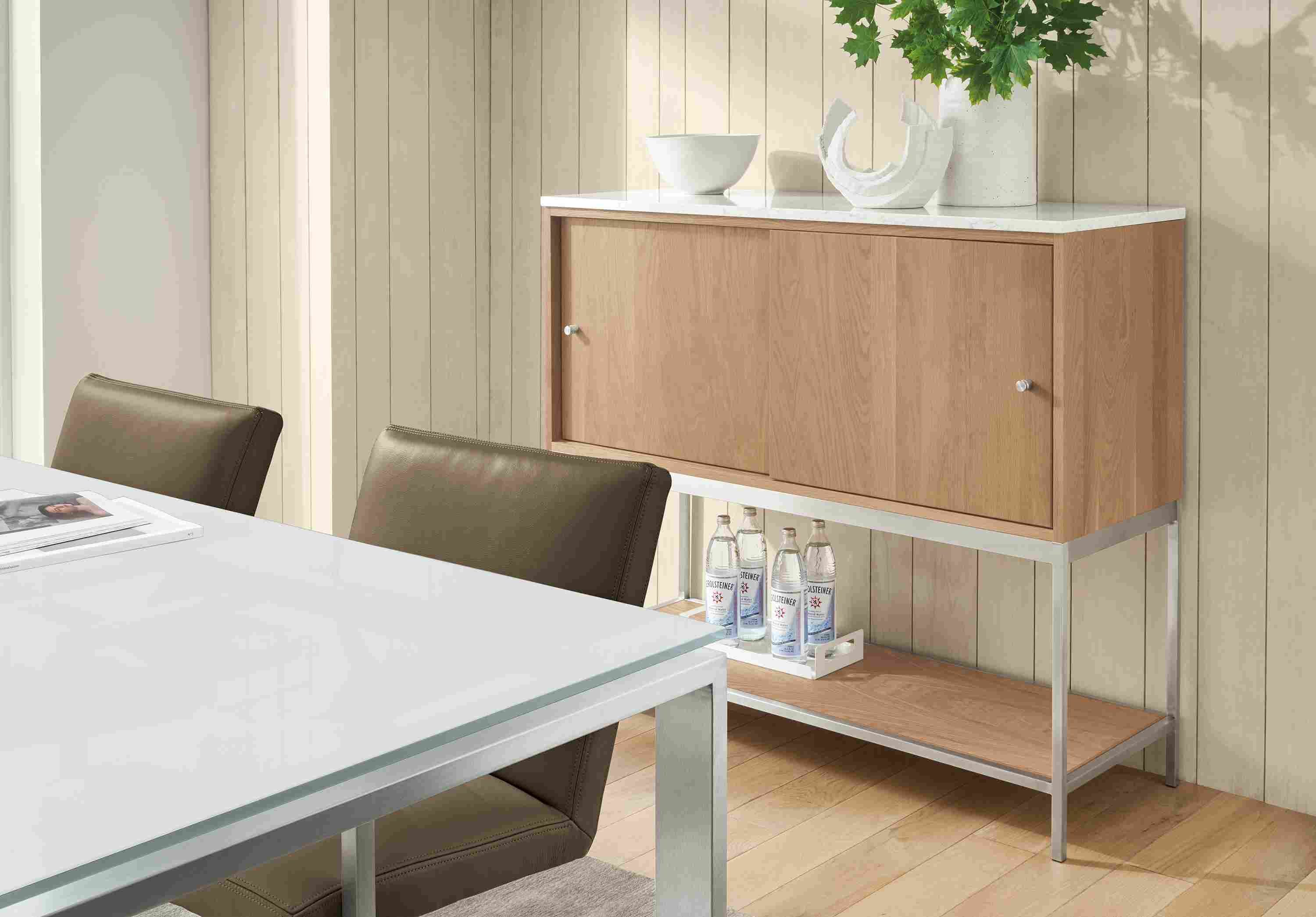 Dining area with Linear 48-wide storage cabinet in rye on red oak, Rand table and Lira chairs in Pesaro Mink.
