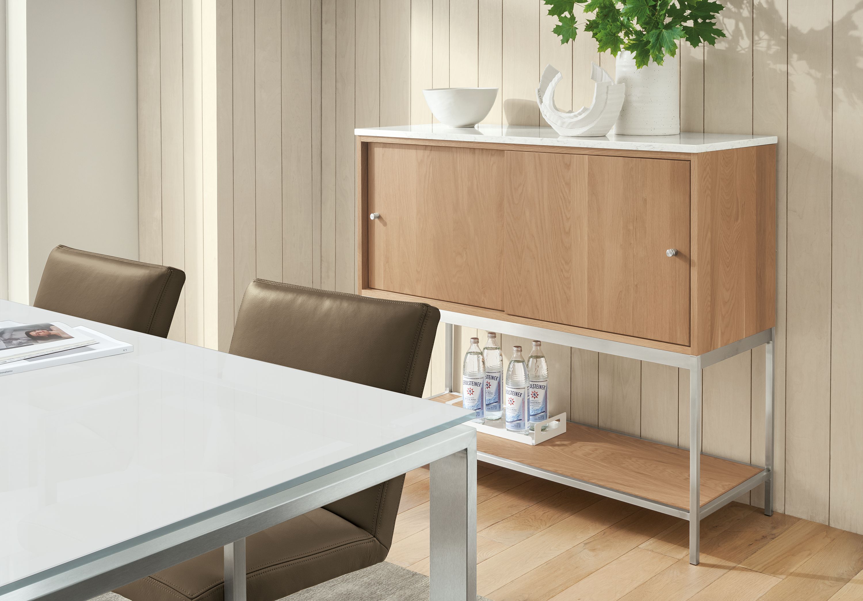 Dining area with Linear 48-wide storage cabinet in rye on red oak, Rand table and Lira chairs in Pesaro Mink.