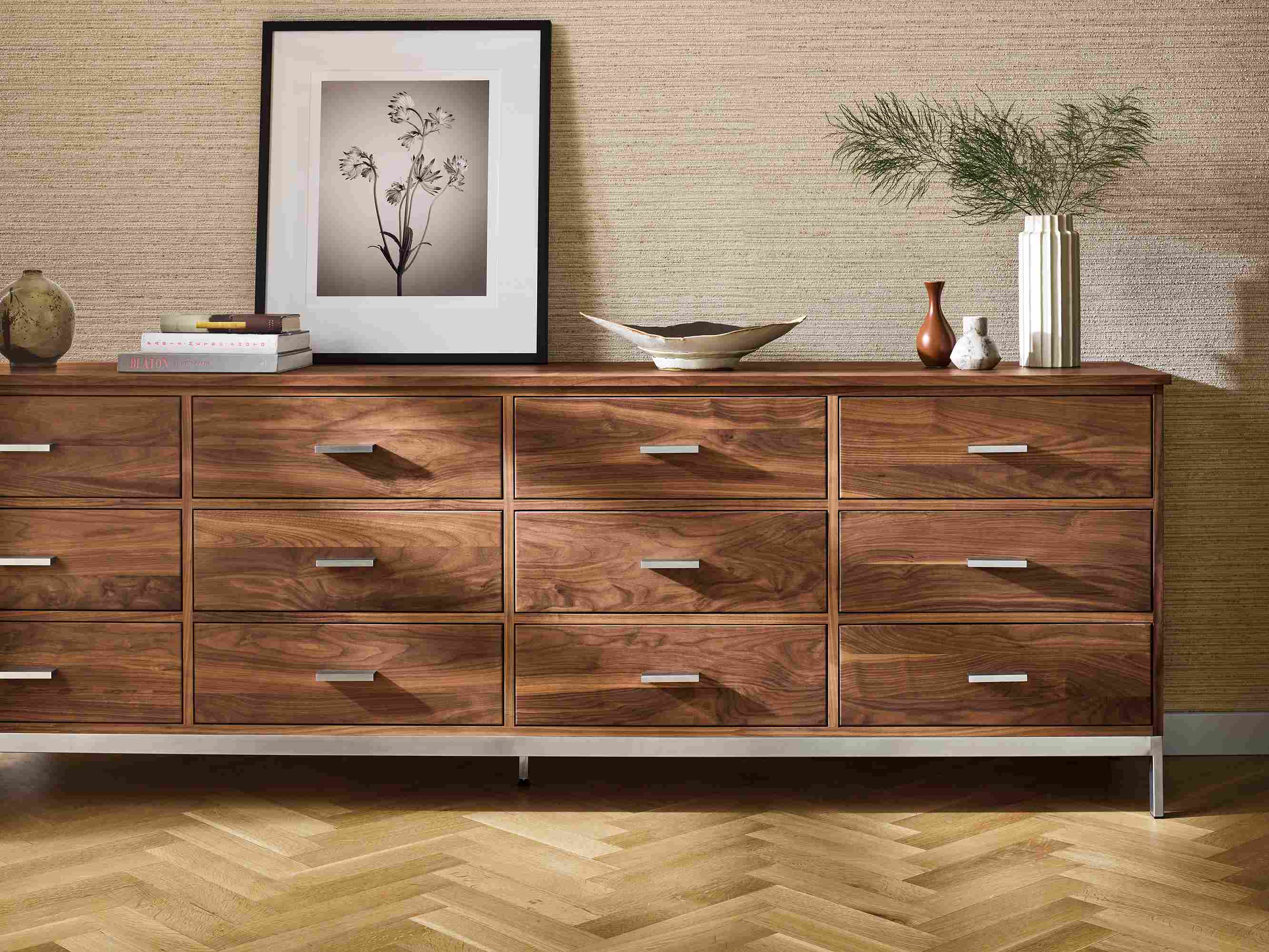 Detail of a Linear 98-wide by 20-deep by 33 twelve- drawer dresser in walnut and Paul Nelson artwork.