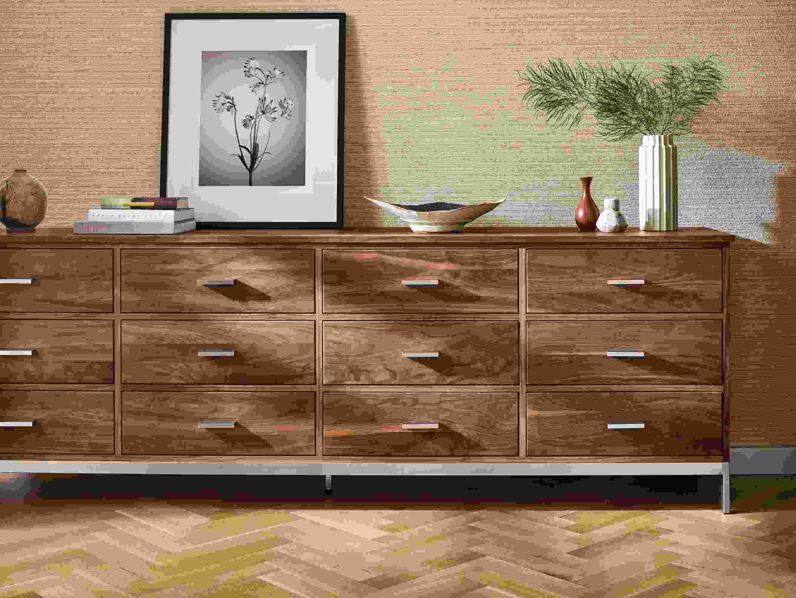 Detail of a Linear 98-wide by 20-deep by 33 twelve- drawer dresser in walnut and Paul Nelson artwork.