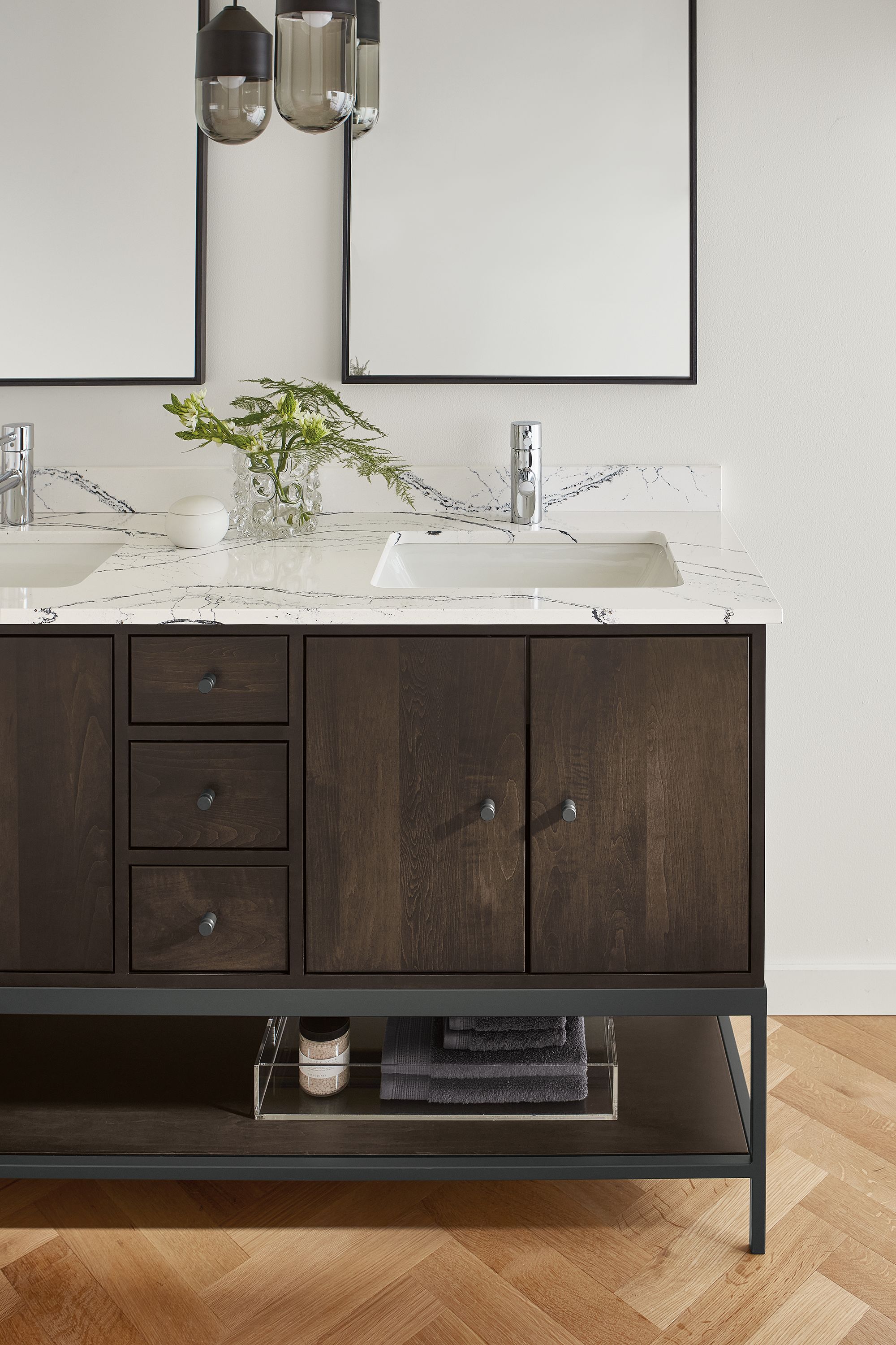detail of linear vanity with charcoal stain and cambria quartz top in bathroom.