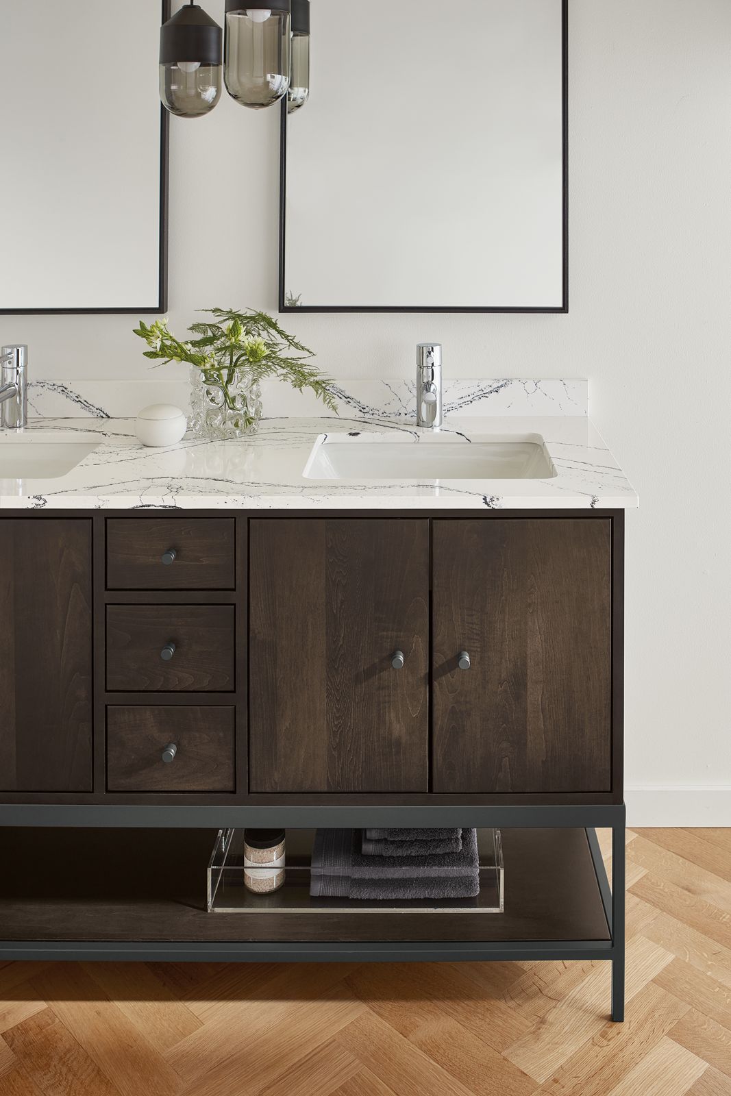 detail of linear vanity with charcoal stain and cambria quartz top in bathroom.
