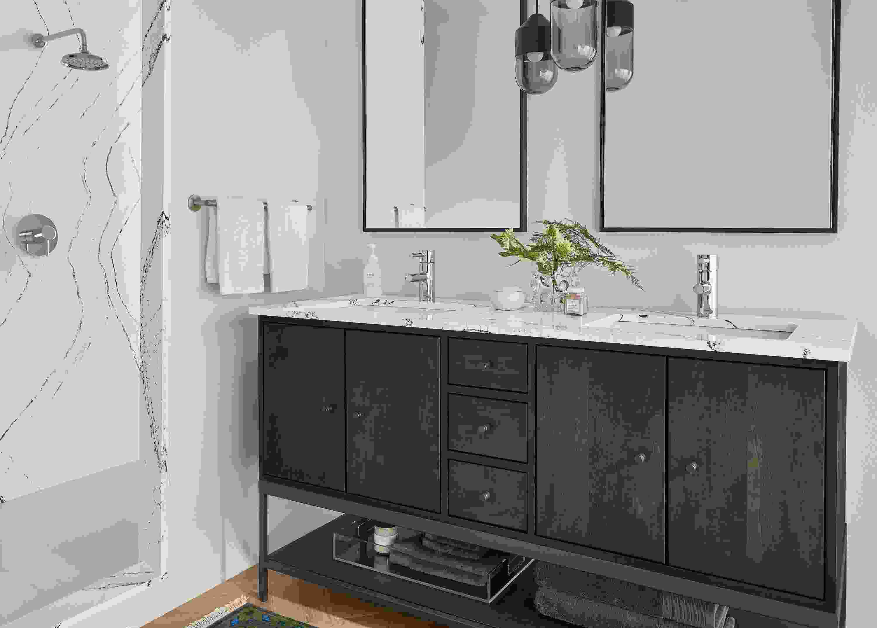 bathroom featuring linear vanity with charcoal stain and cambria quartz top.