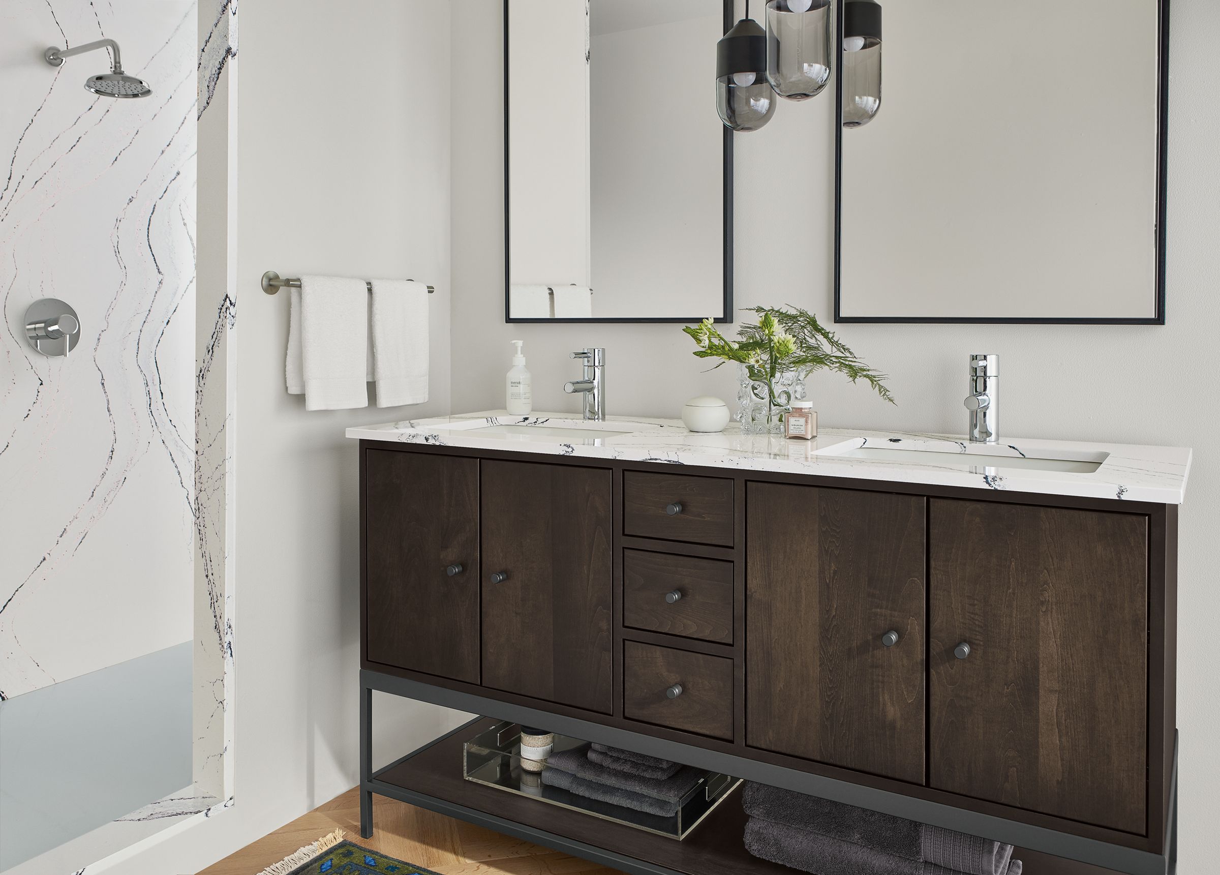 bathroom featuring linear vanity with charcoal stain and cambria quartz top.