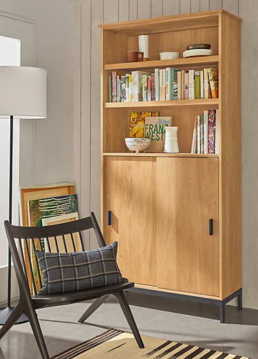 Detail of tall Linear modular custom cabinet in white oak with natural steel base and hardware.