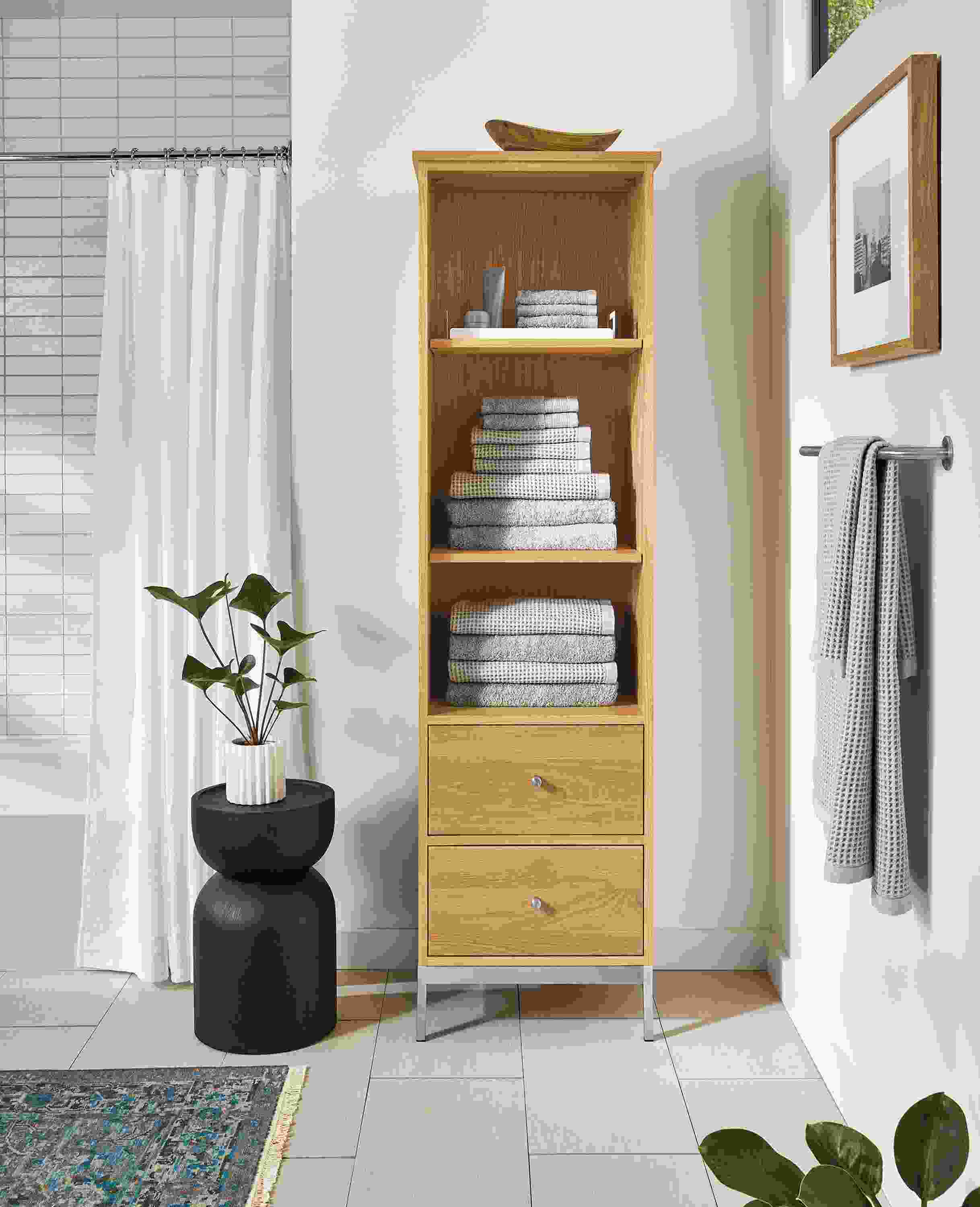 Bathroom with Linear 20-wide freestanding linen cabinet and Nyla stool in red oak with charcoal stain.