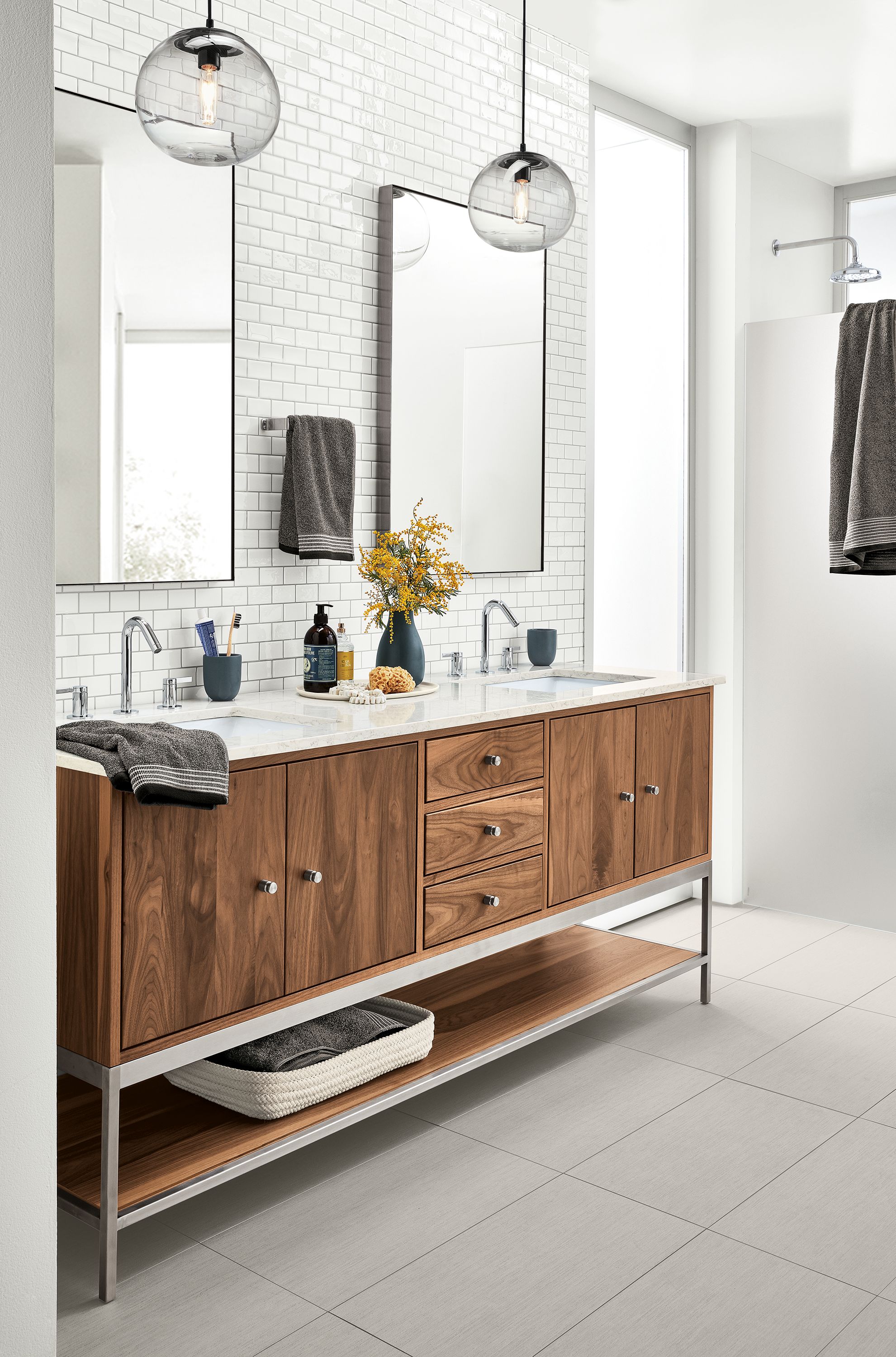 Bathroom with Linear double sink vanity in walnut and stainless steel.