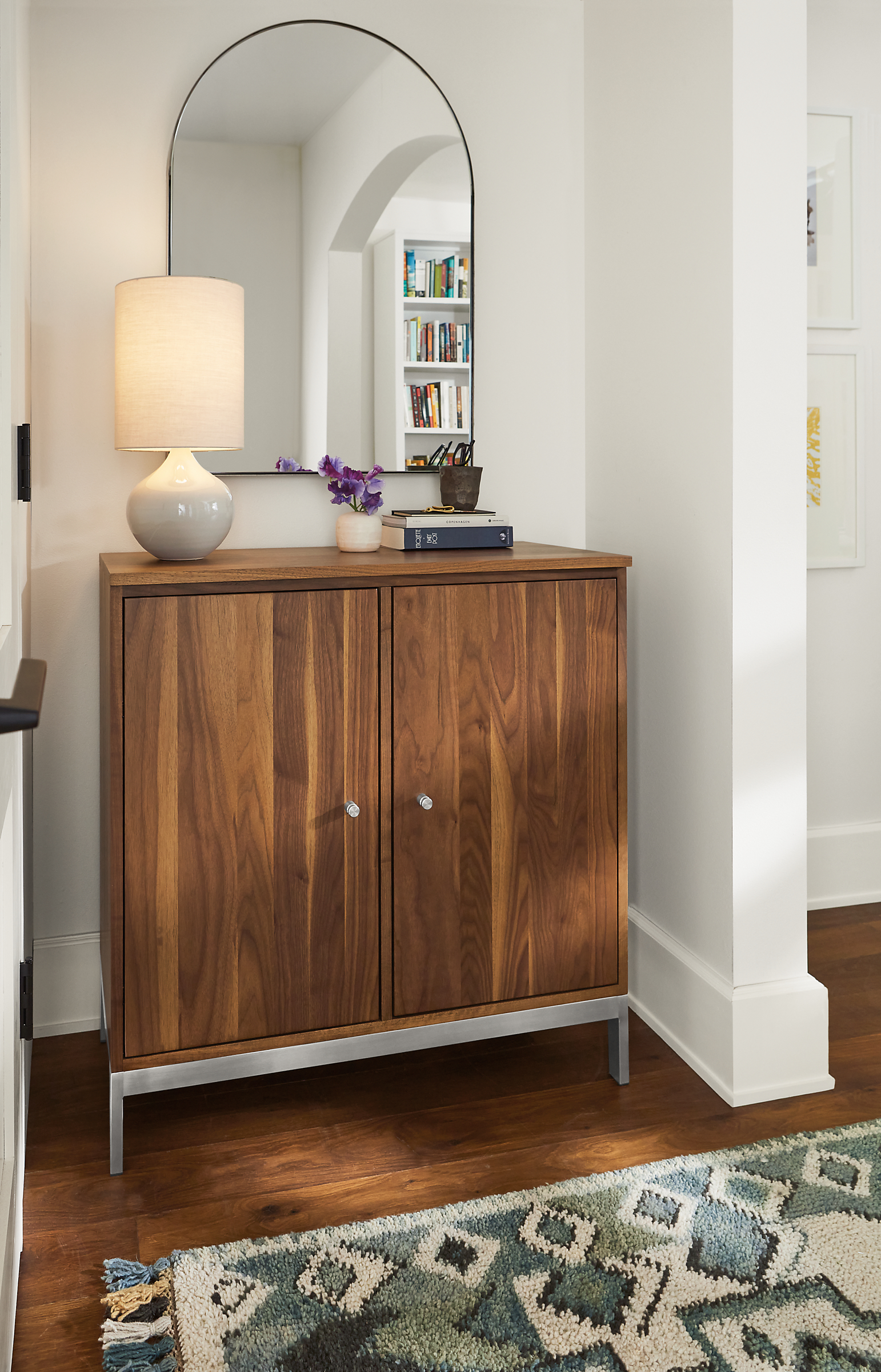 entryway featuring linear storage cabinet in walnut and stainless steel