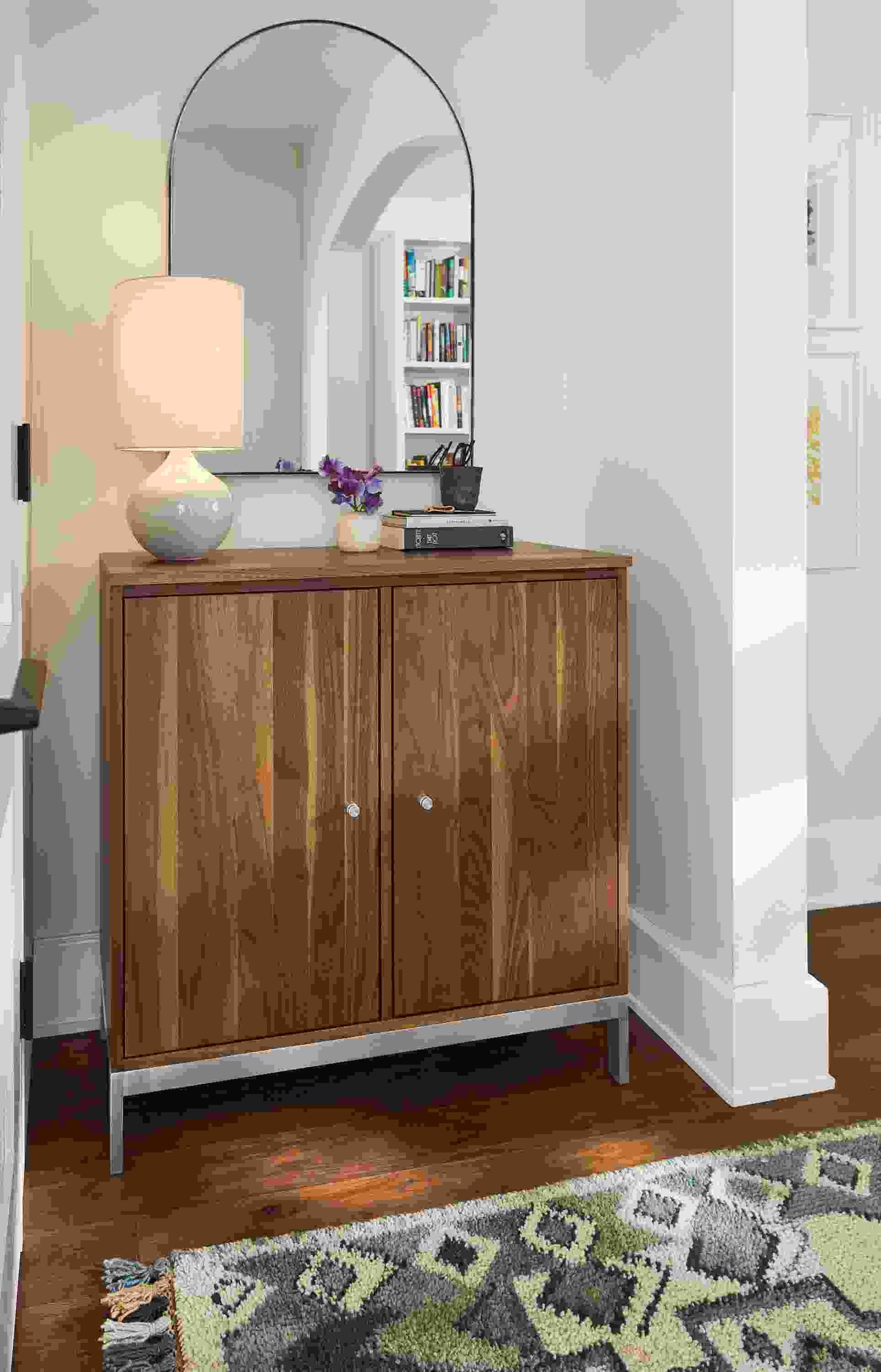 entryway featuring linear storage cabinet in walnut and stainless steel