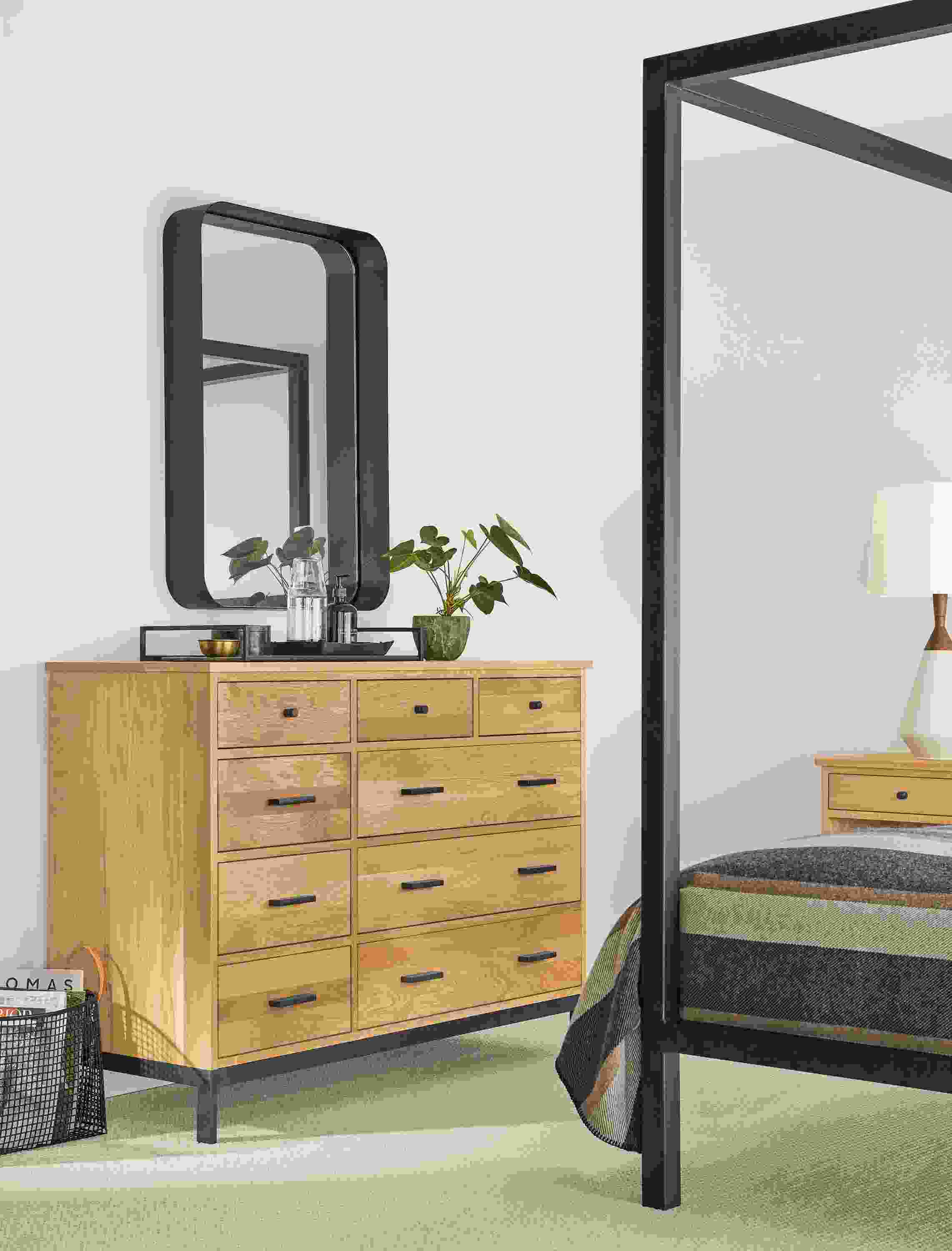 Detail of Linear dresser in white oak in bedroom below wall mirror.