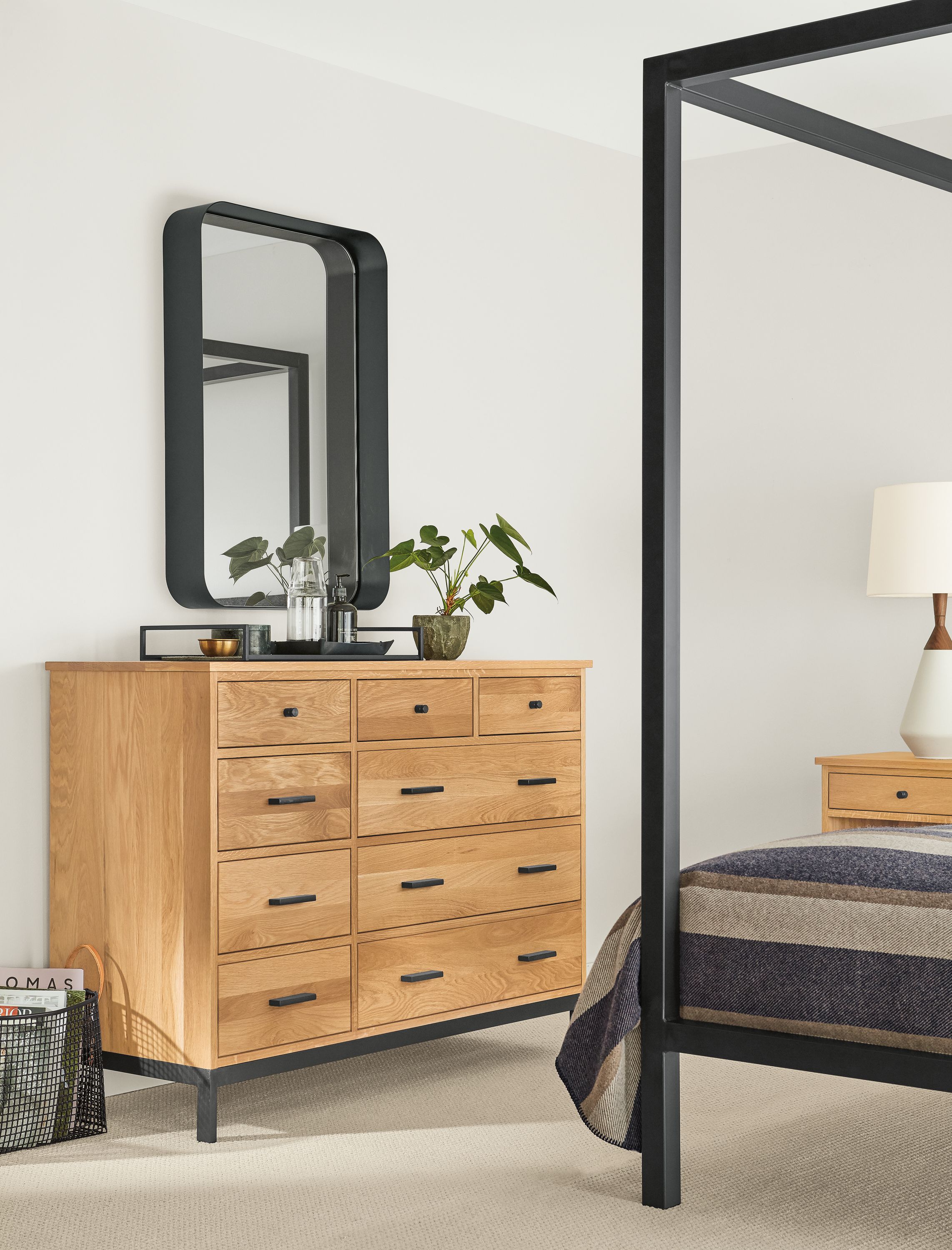 Detail of Linear dresser in white oak in bedroom below wall mirror.