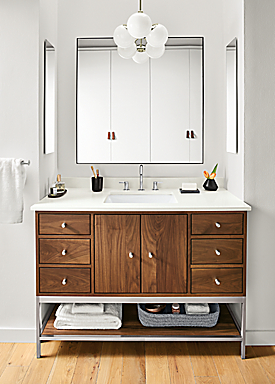 Detail of Linear bathroom vanity in walnut and stainless steel in bathroom.