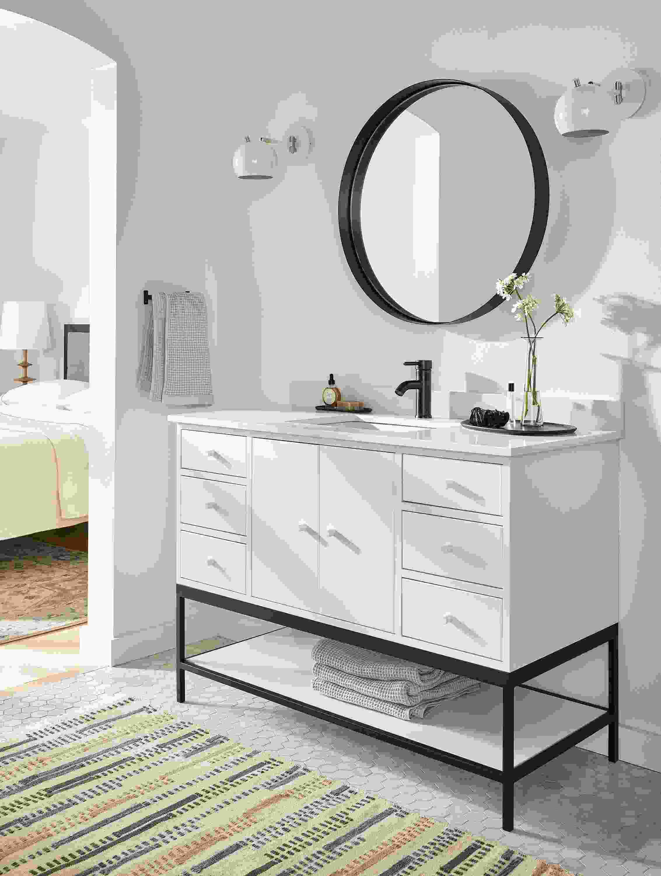 bathroom with 48-wide linear vanity in white, reeves mirror, camber sconces, morse rug.