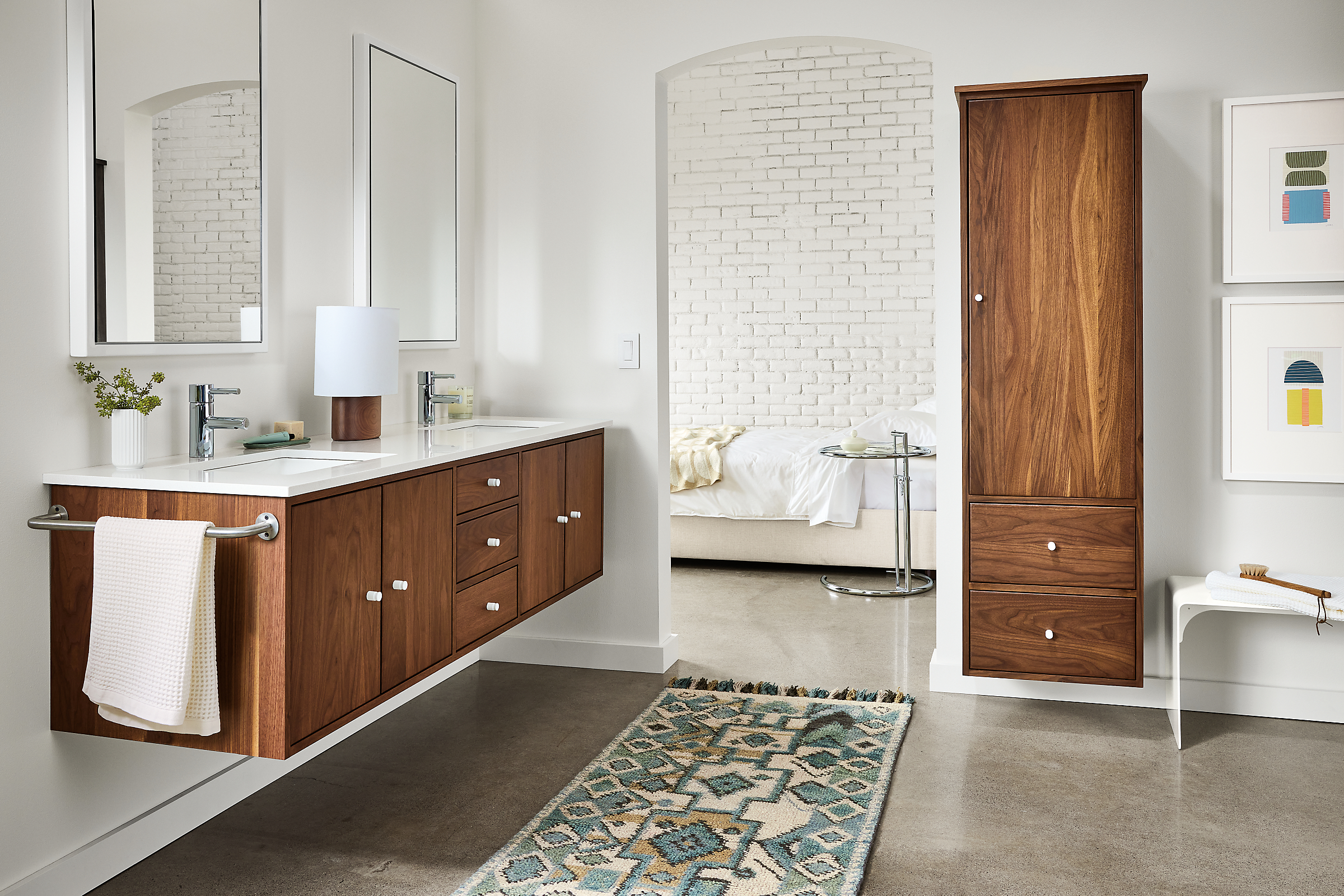 Bathroom with Linear floating vanity in walnut with double sink and Ona rug in ocean.