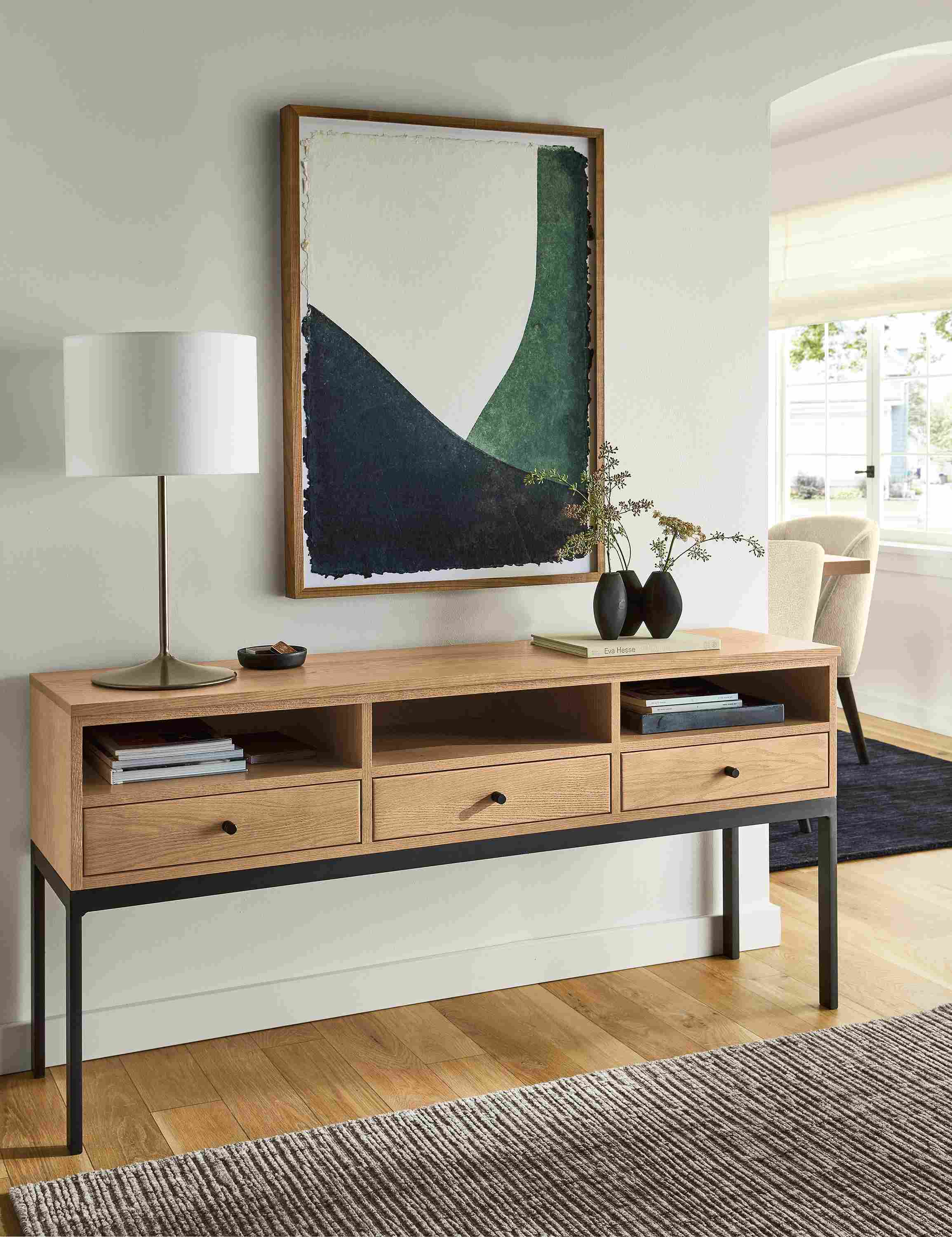 Living room with linear 60-wide, 3-drawer console table in rye on red oak and John Robshaw limited edition print in indigo/green.