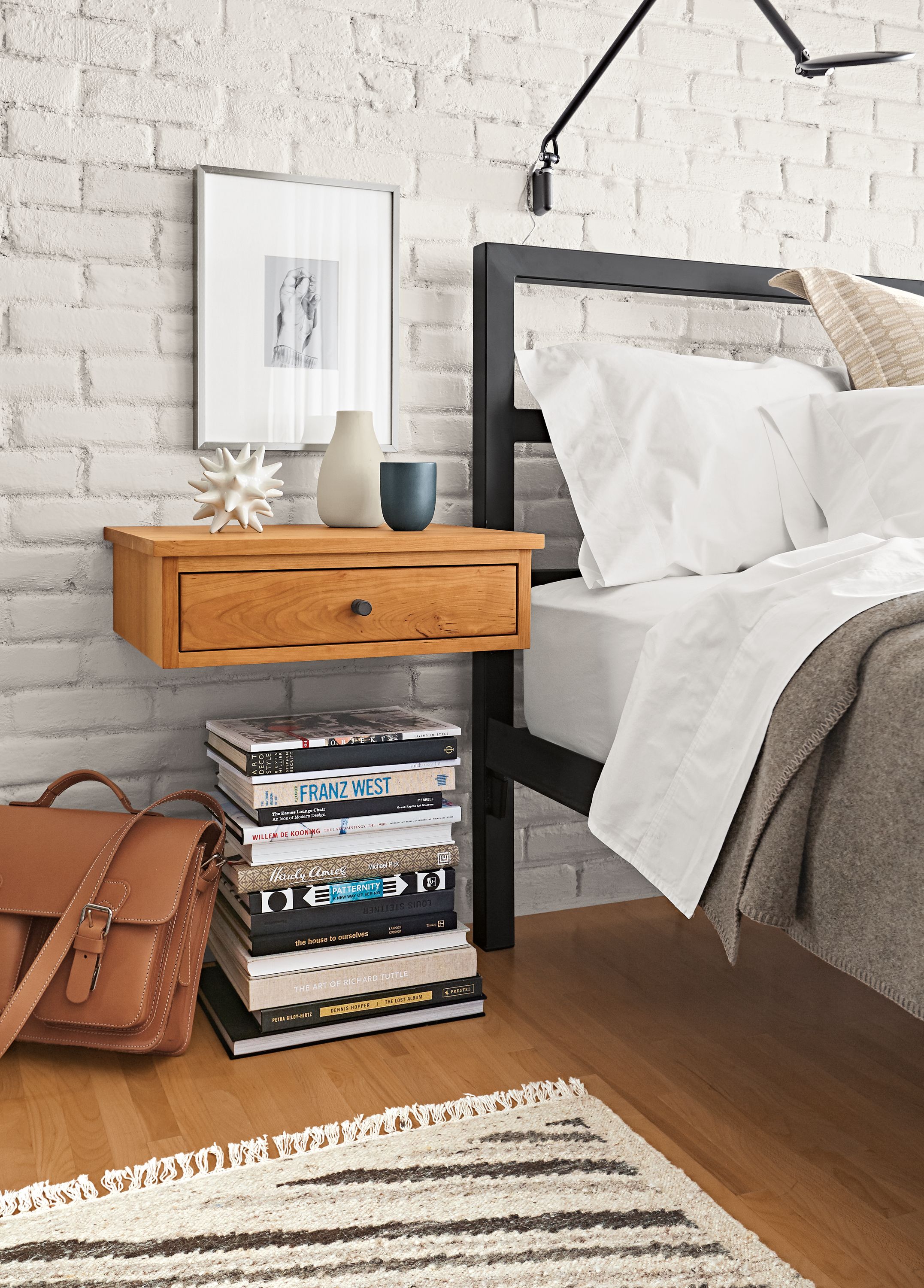 Detail of Linear wall-mounted nightstand in cherry.