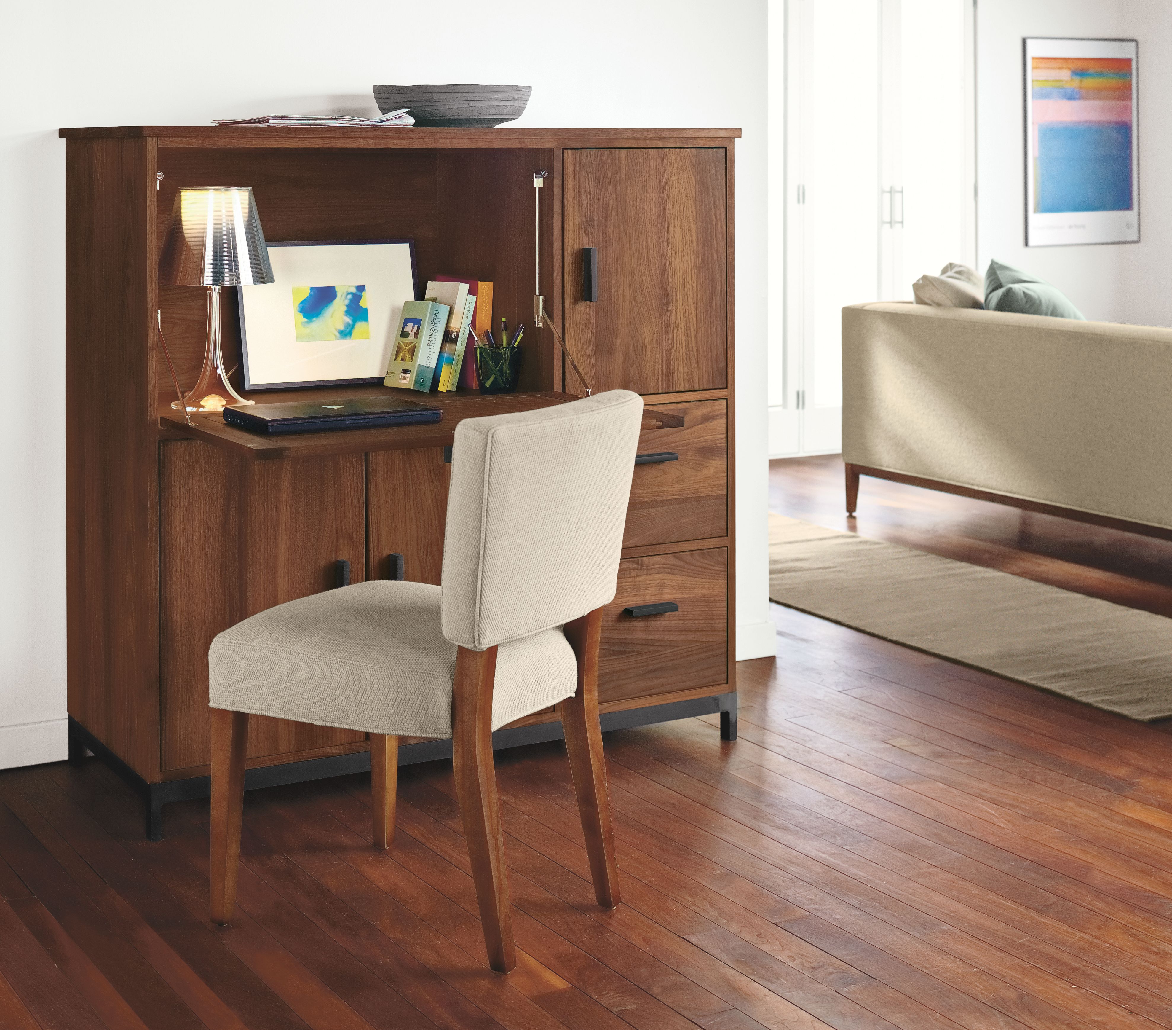 Office with Linear office armoire with steel base in walnut.