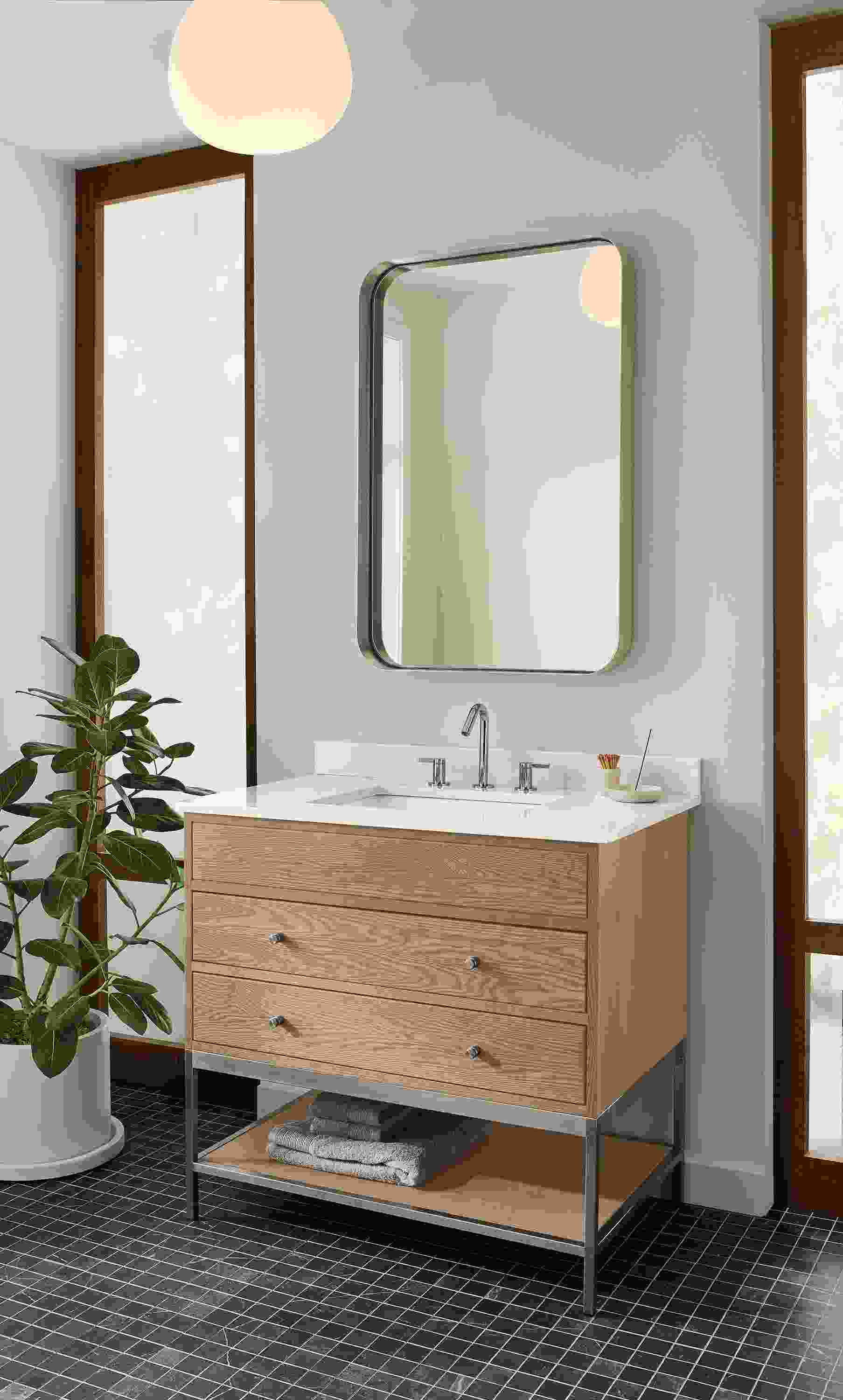 Bathroom with Linear single-sink vanity with drawers and shelf in rye on red oak with light grey quartz.