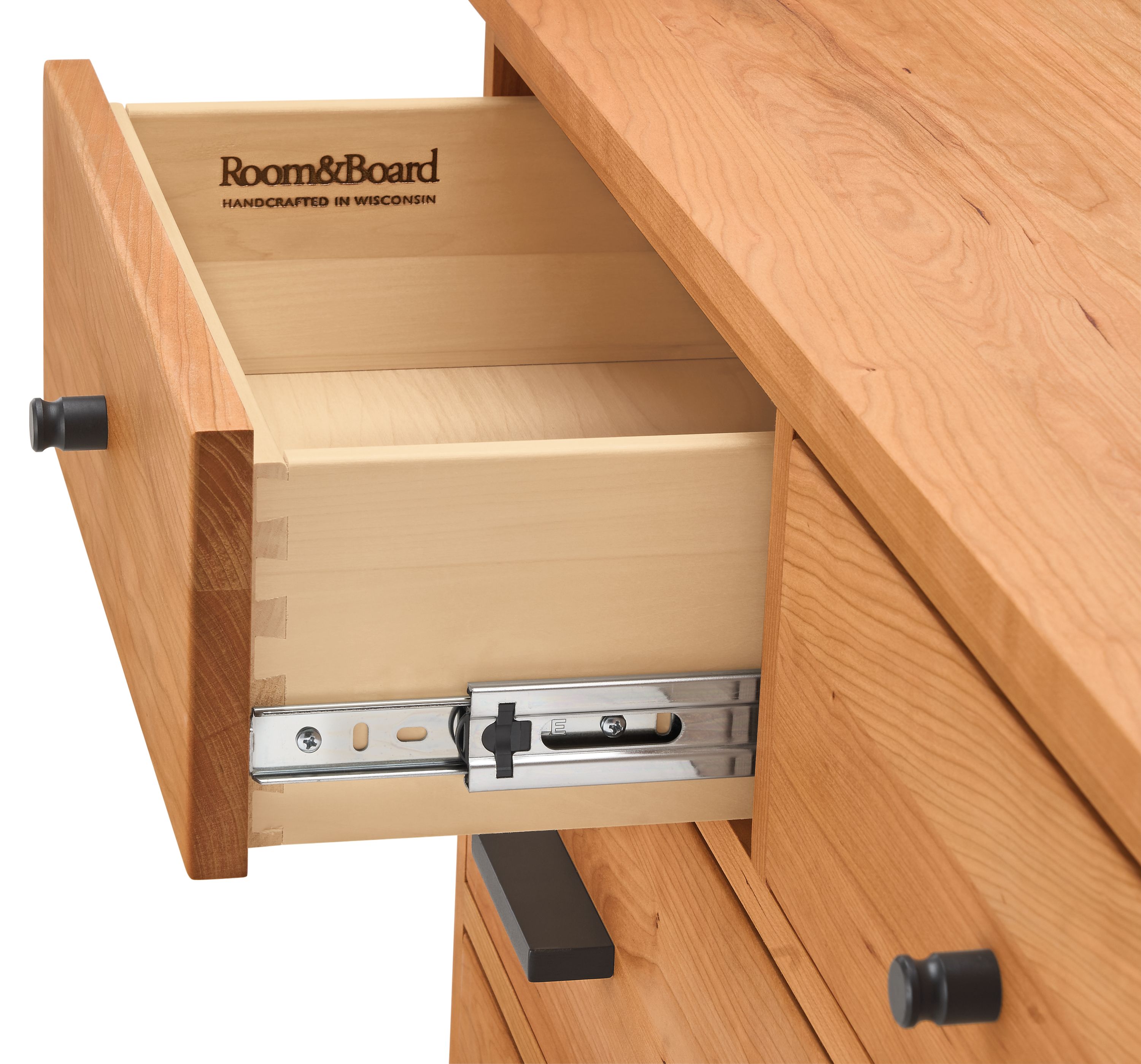 Detail of open drawer and slide mechanism on Linear 10-drawer dresser in cherry finish.