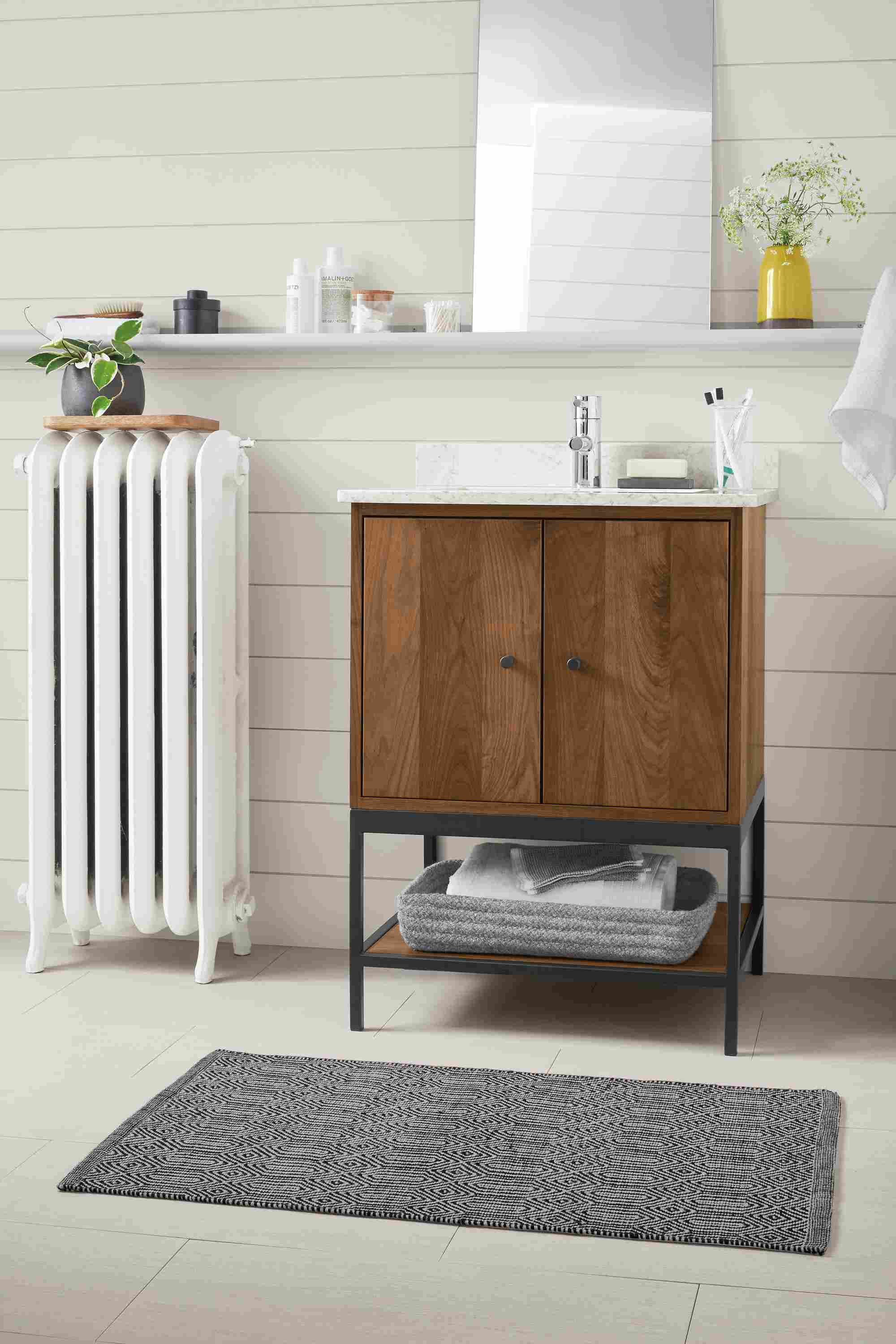 Bathroom with Linear vanity with steel base in walnut.