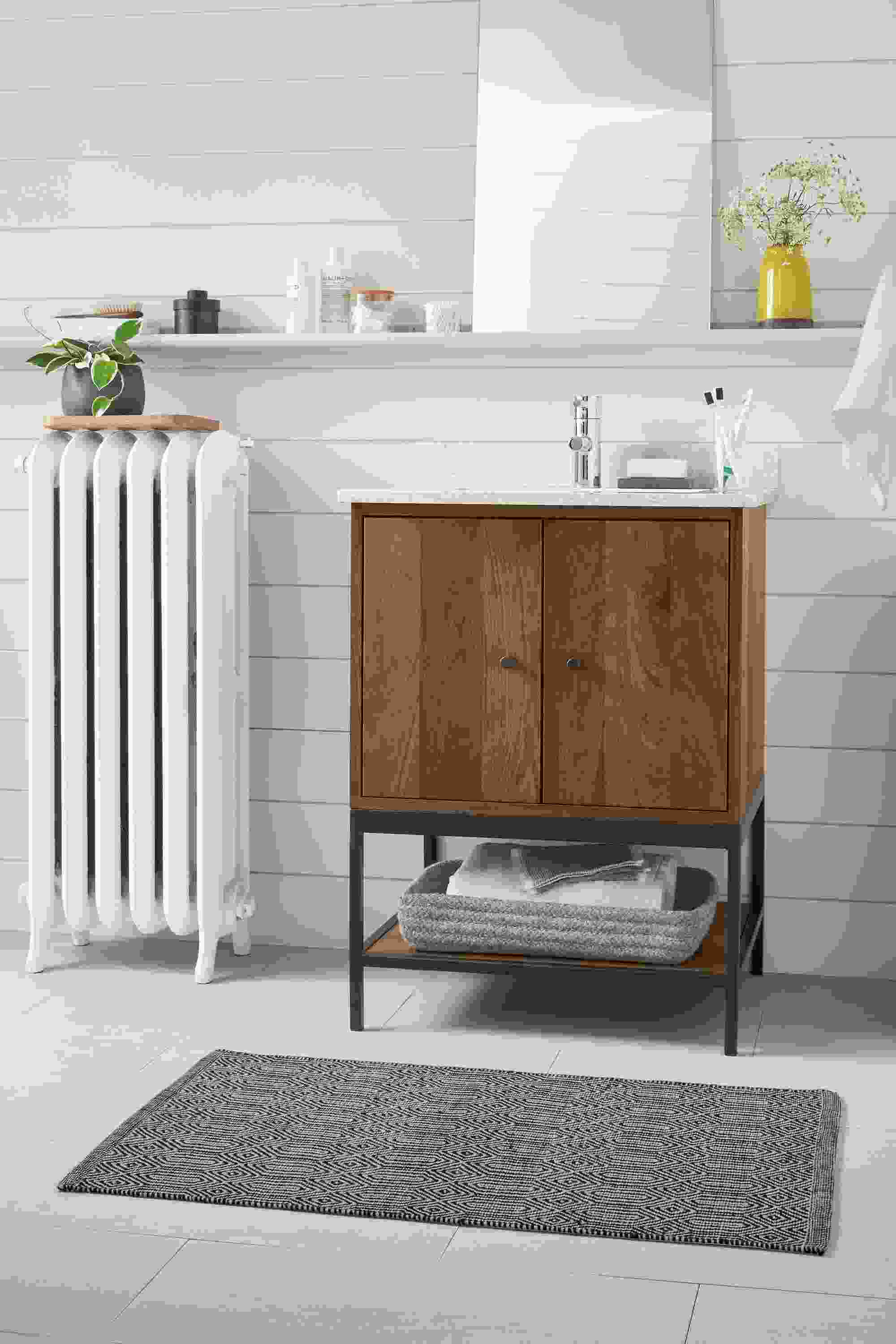 Bathroom with Linear vanity with steel base in walnut.