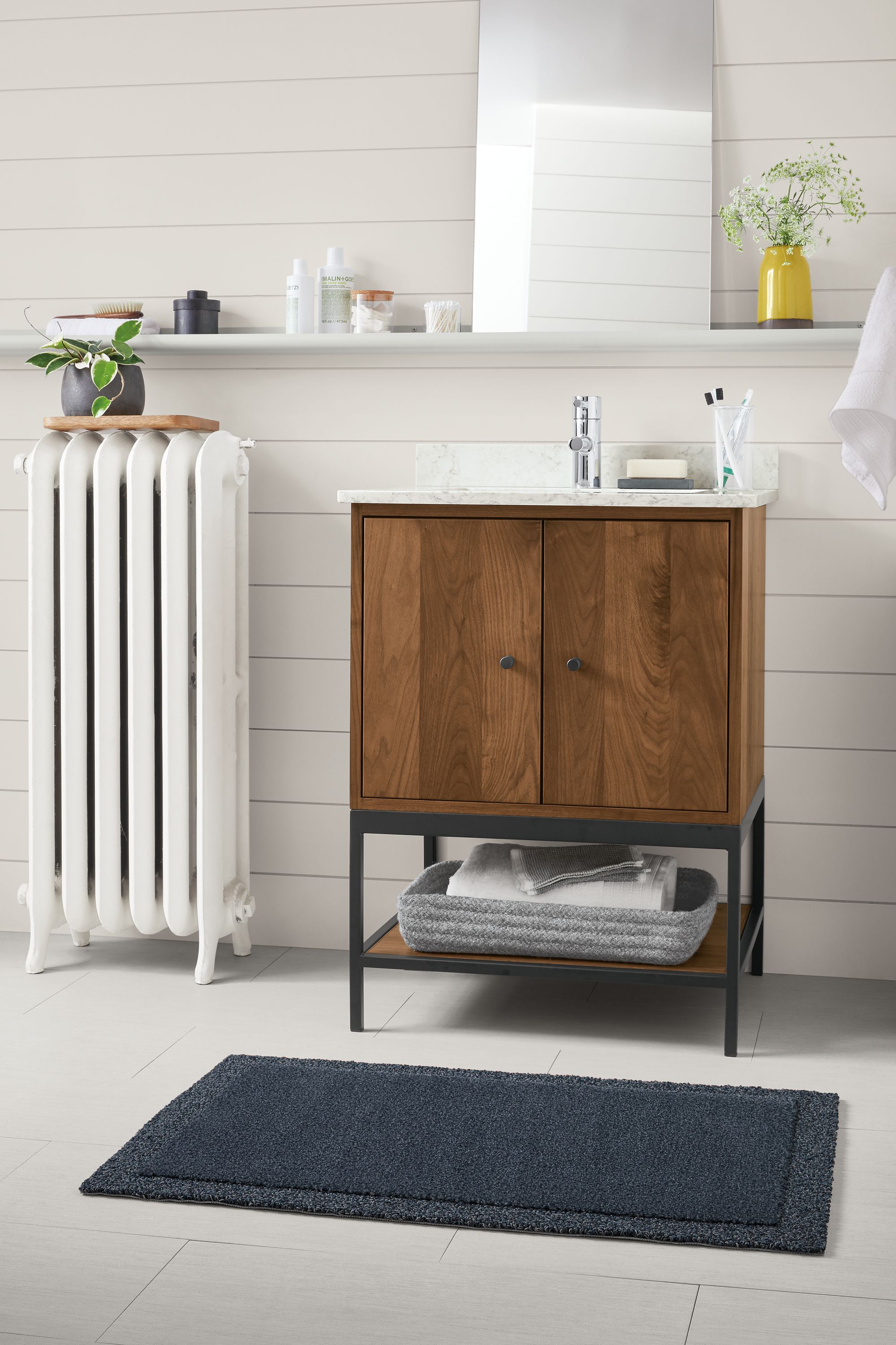 Bathroom with Linear vanity with steel base in walnut.